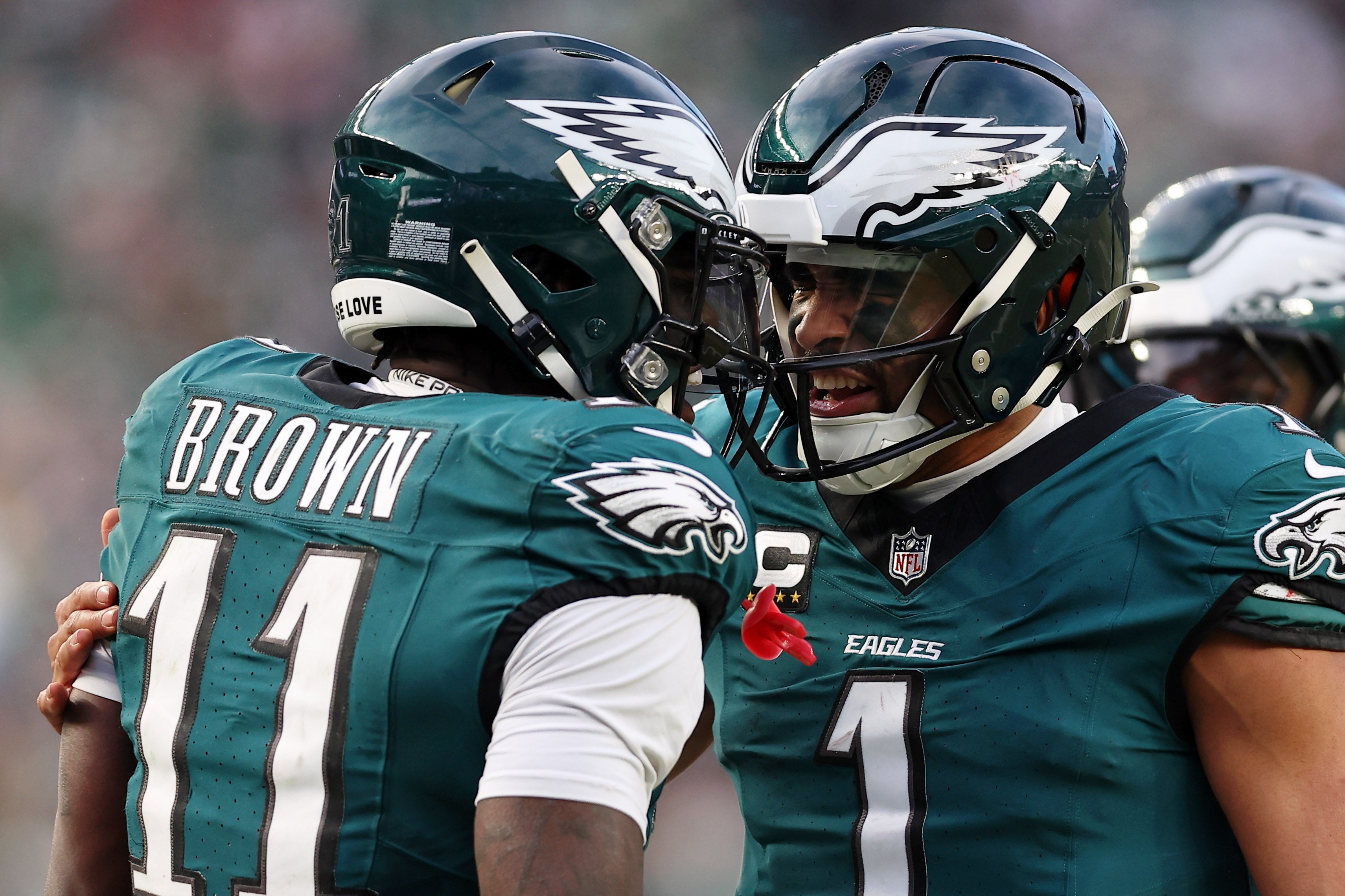 Philadelphia Eagles quarterback Jalen Hurts (1) and wide receiver A.J. Brown (11) celebrate after a touchdown against the Washington Commanders during the first half in the NFC Championship game.