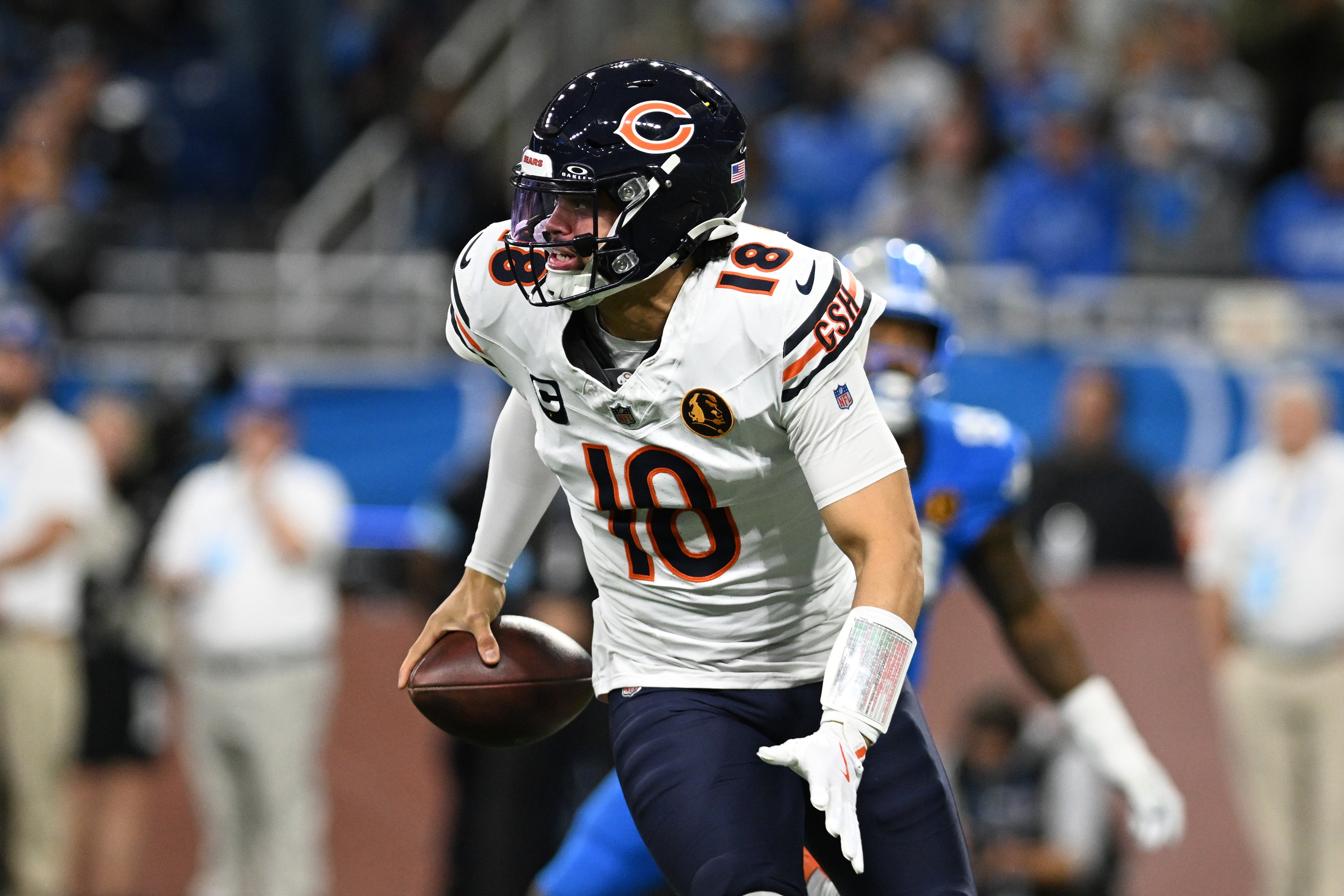 Nov 28, 2024; Detroit, Michigan, USA; Chicago Bears quarterback Caleb Williams (18) scrambles out of the pocket against the Detroit Lions in the second quarter at Ford Field.