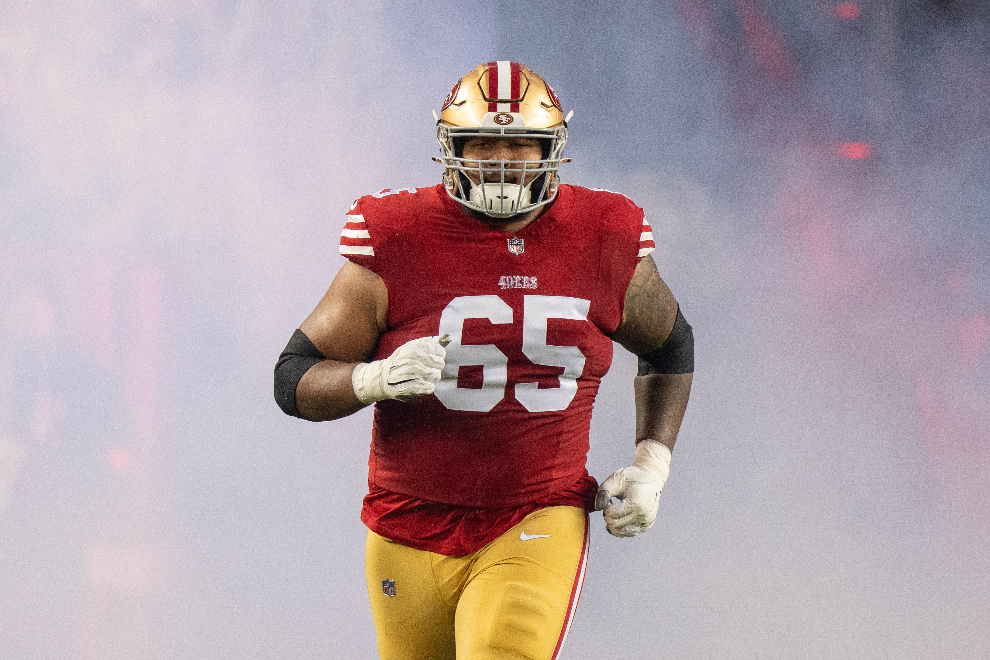 San Francisco 49ers guard Aaron Banks (65) before a 2024 NFC divisional round game against the Green Bay Packers at Levi's Stadium.