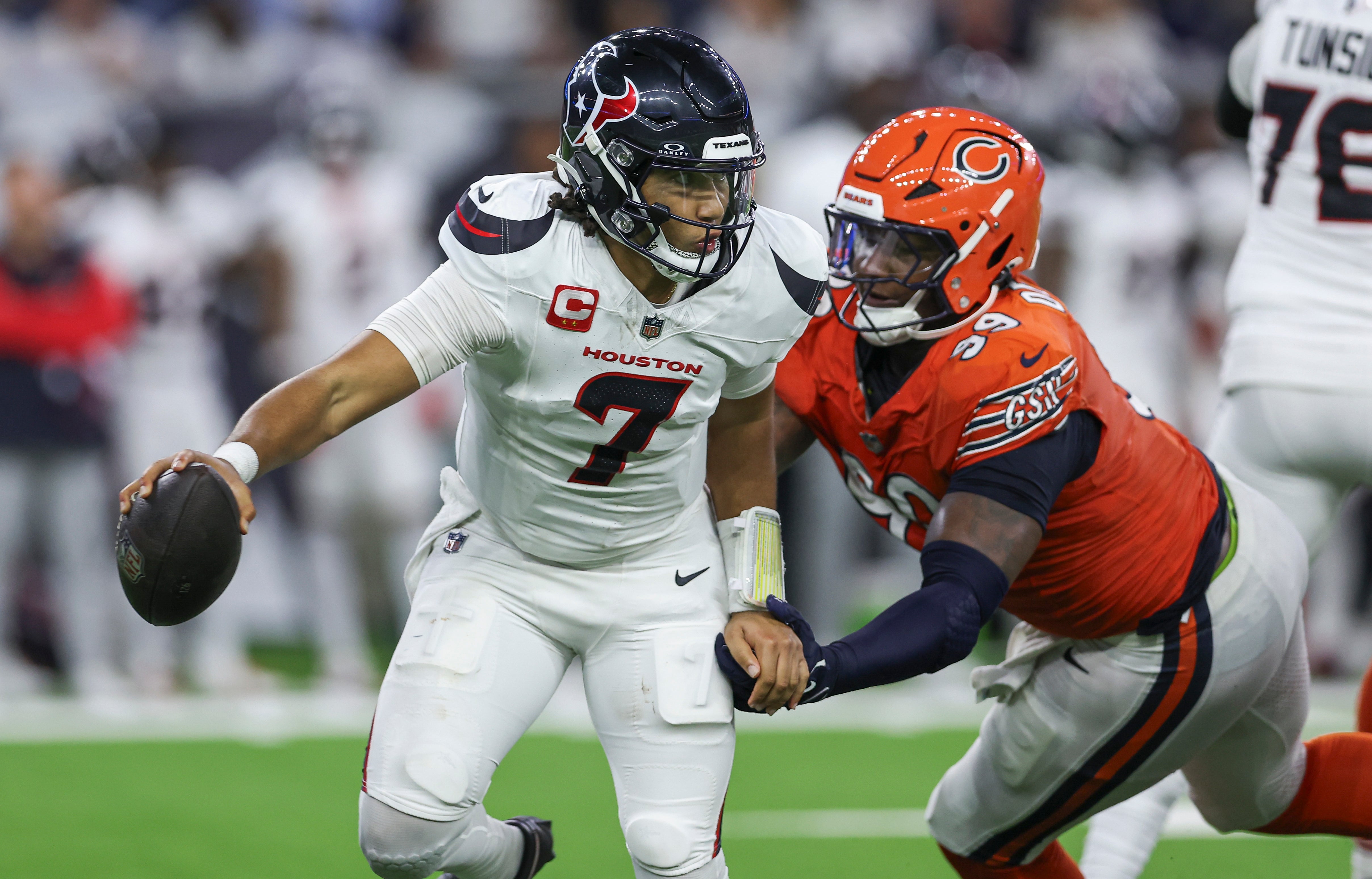 Sep 15, 2024; Houston, Texas, USA; Houston Texans quarterback C.J. Stroud (7) attempts to escape a tackle by Chicago Bears defensive tackle Gervon Dexter Sr. (99) during the fourth quarter at NRG Stadium.