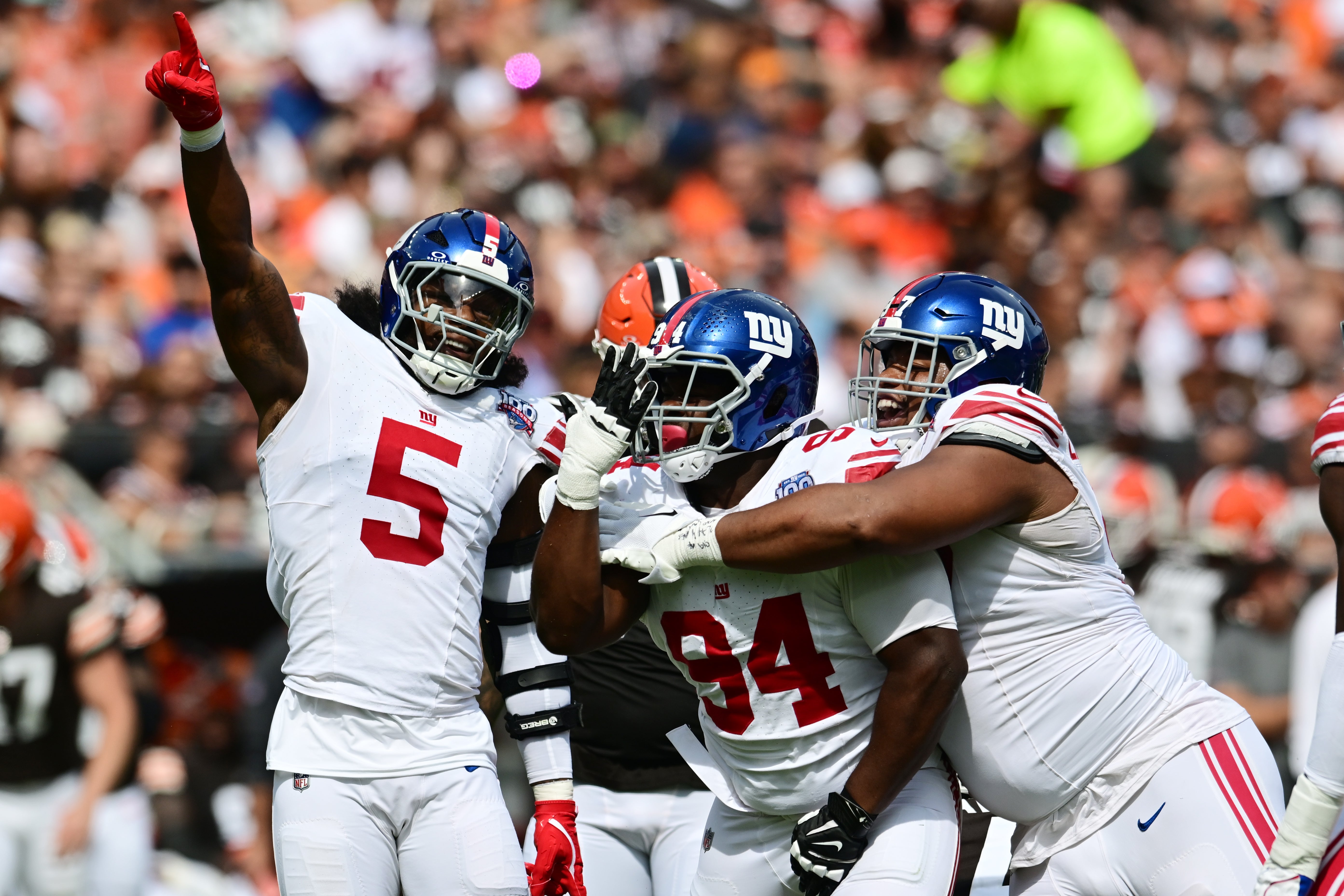 Sep 22, 2024; Cleveland, Ohio, USA; New York Giants linebacker Kayvon Thibodeaux (5) and defensive tackle Elijah Chatman (94) and defensive tackle Dexter Lawrence II (97) celebrate after sacking Cleveland Browns quarterback Deshaun Watson (not pictured) during the first quarter at Huntington Bank Field.