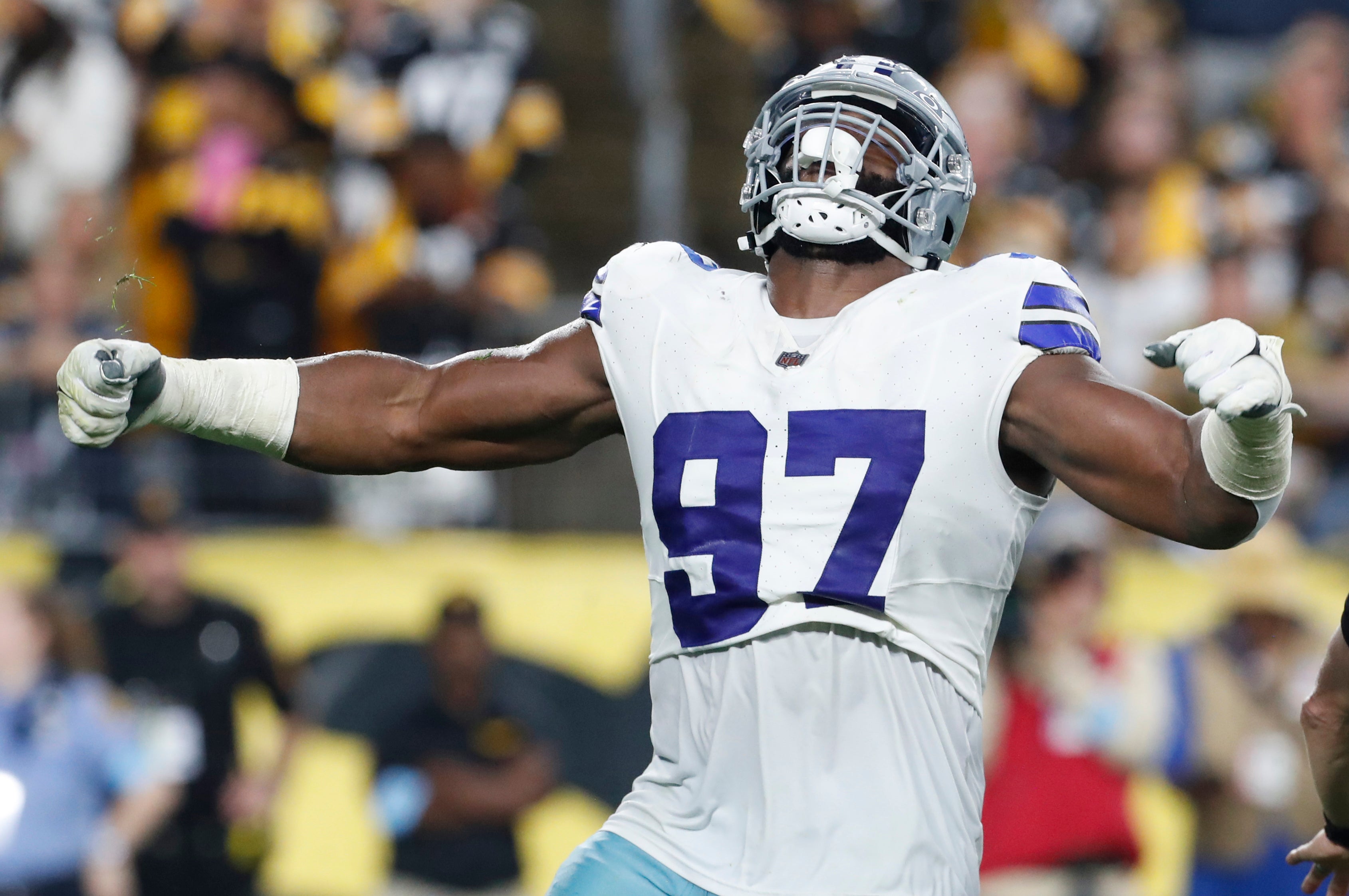 Dallas Cowboys defensive tackle Osa Odighizuwa (97) reacts to sacking Pittsburgh Steelers quarterback Justin Fields (not pictured) during the second quarter at Acrisure Stadium.