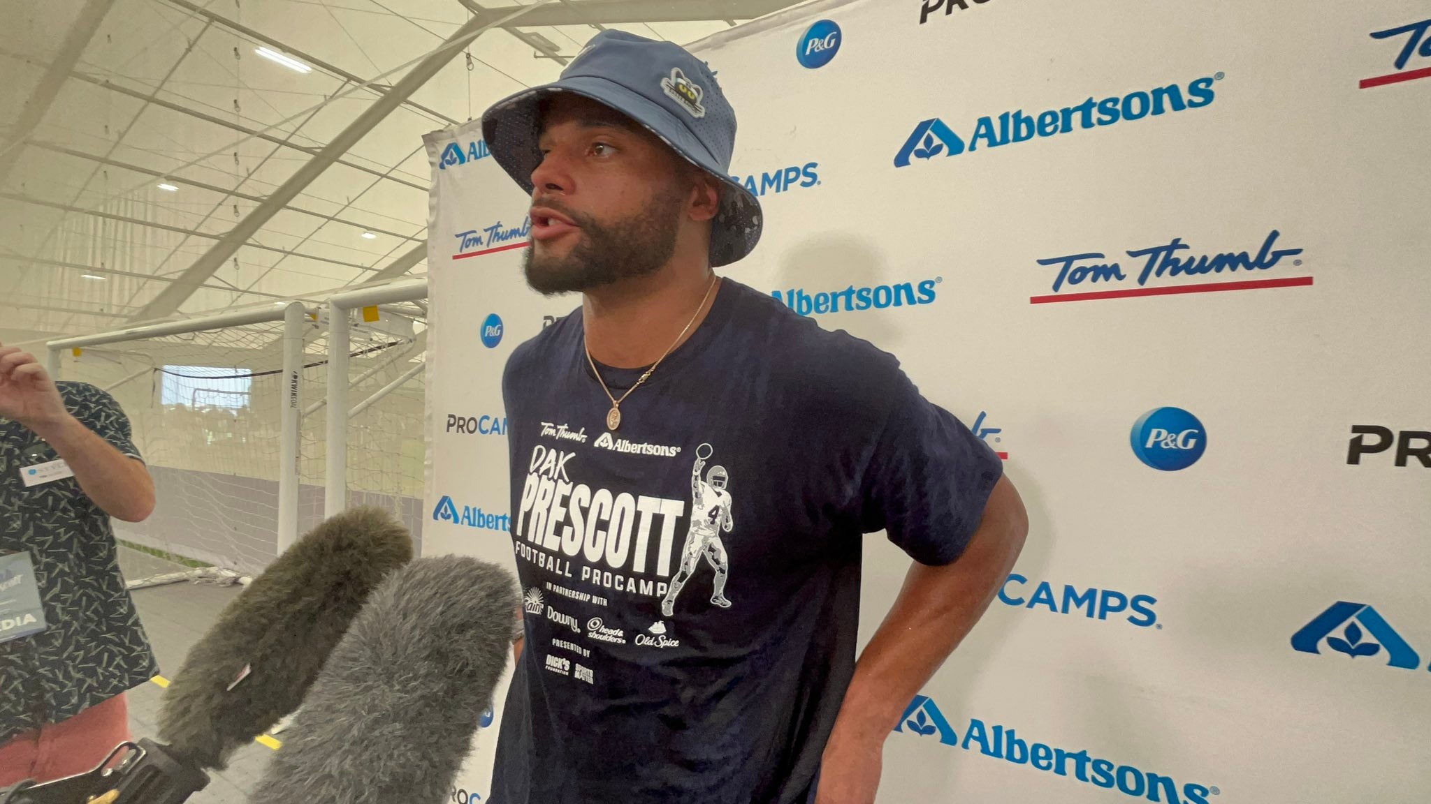 Dallas Cowboys QB Dak Prescott talks to reporters at his free ProCamps football camp.