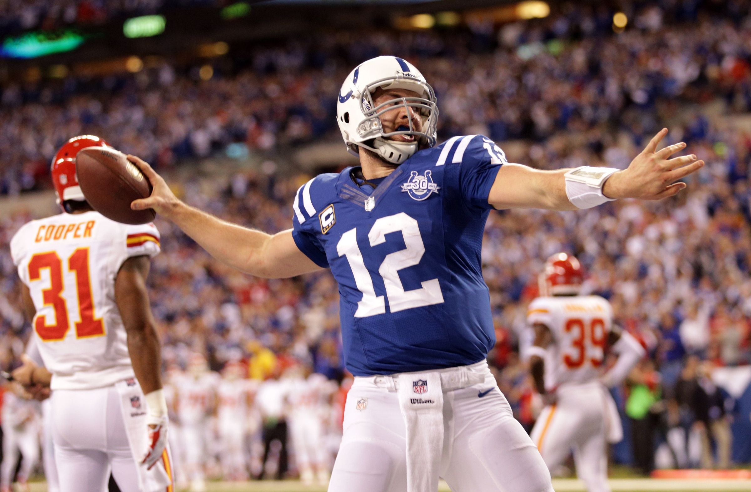 Indianapolis Colts Andrew Luck spikes the ball after his fourth quarter touchdown against the Kansas City Chiefs in the first round of the NFL playoffs, Lucas Oil Stadium, Indianapolis, Saturday, January 04, 2014.