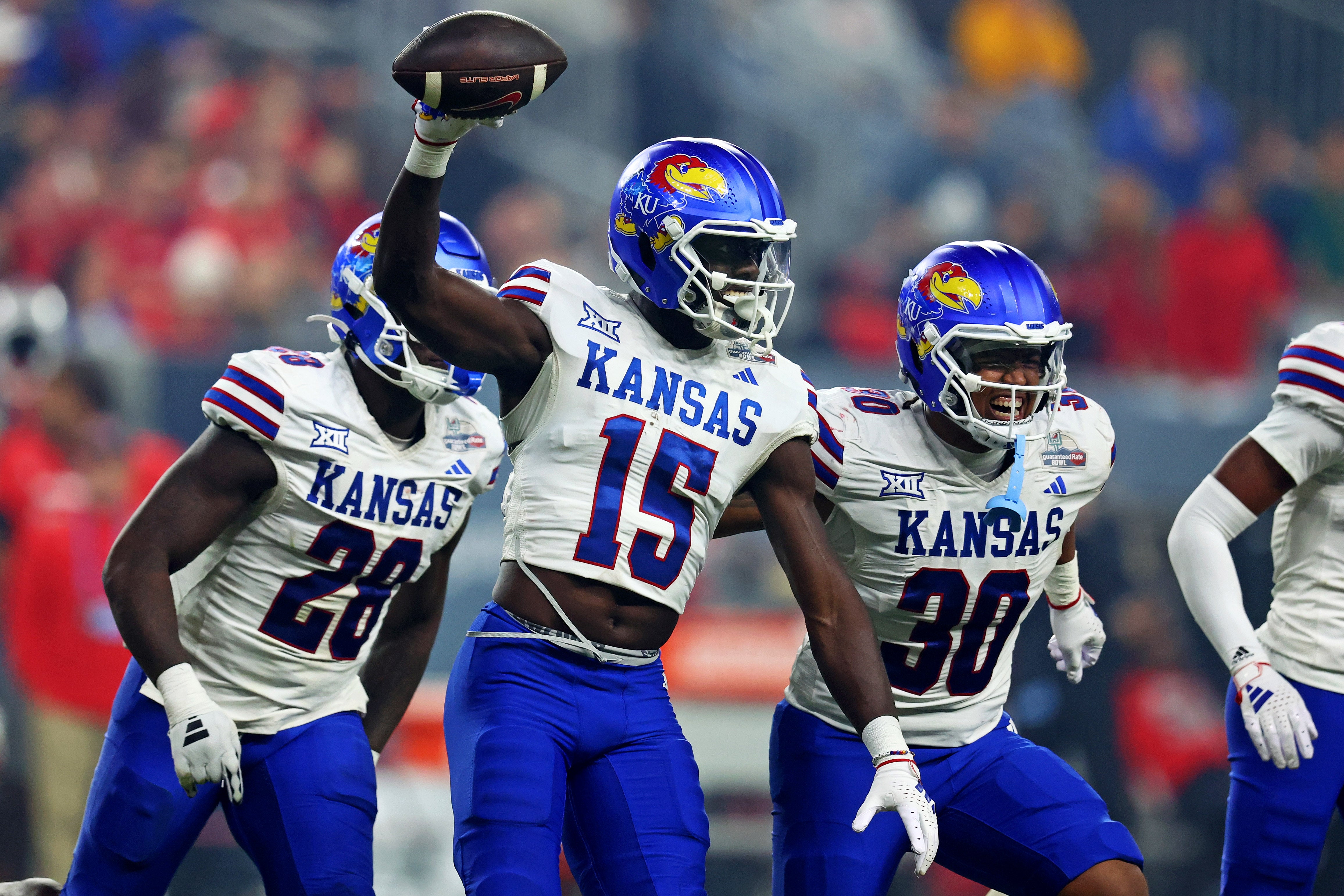 Dec 26, 2023; Phoenix, AZ, USA; Kansas Jayhawks linebacker Craig Young (15) celebrates with his teammates after making an interception during the second half against the UNLV Rebels in the Guaranteed Rate Bowl at Chase Field.