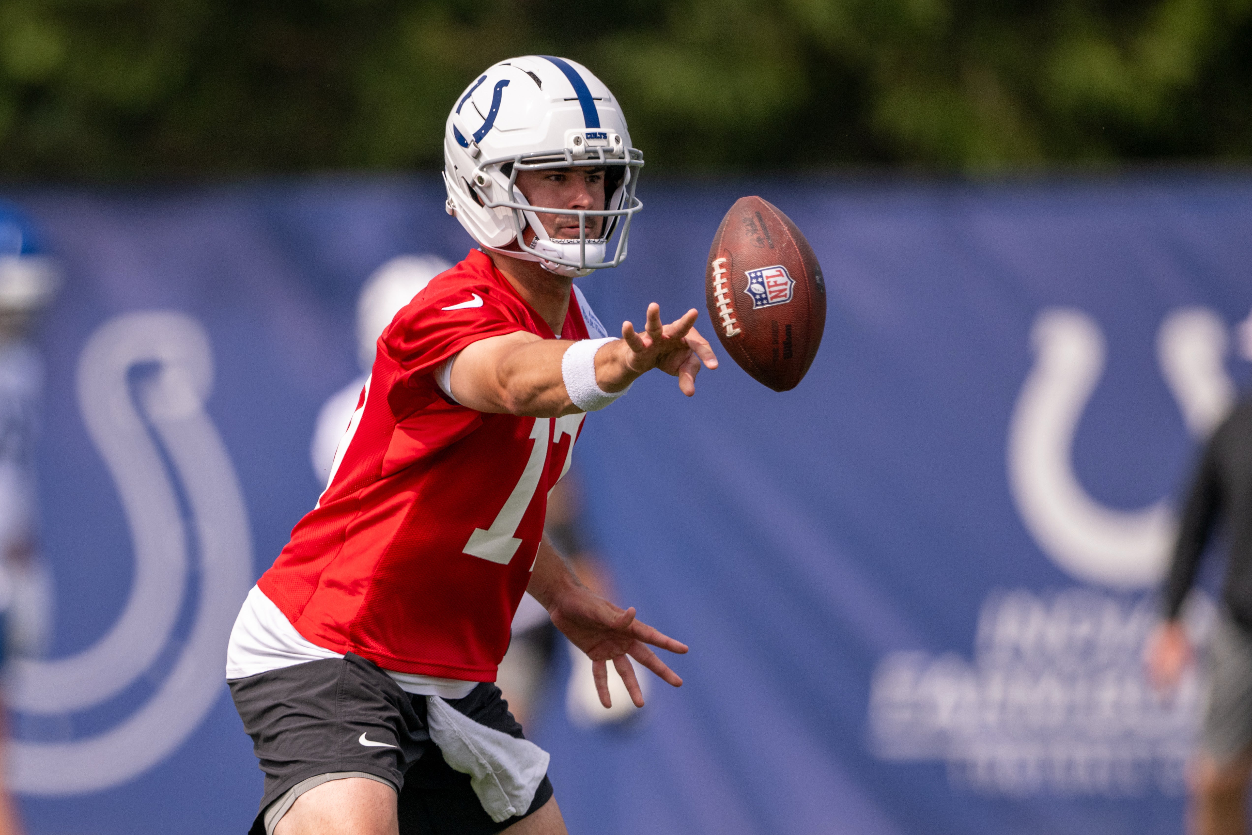 Jun 12, 2025; Indianapolis, IN, USA; Indianapolis Colts quarterback Daniel Jones (17) pitches a ball during training camp at the Farm Bureau Football complex.
