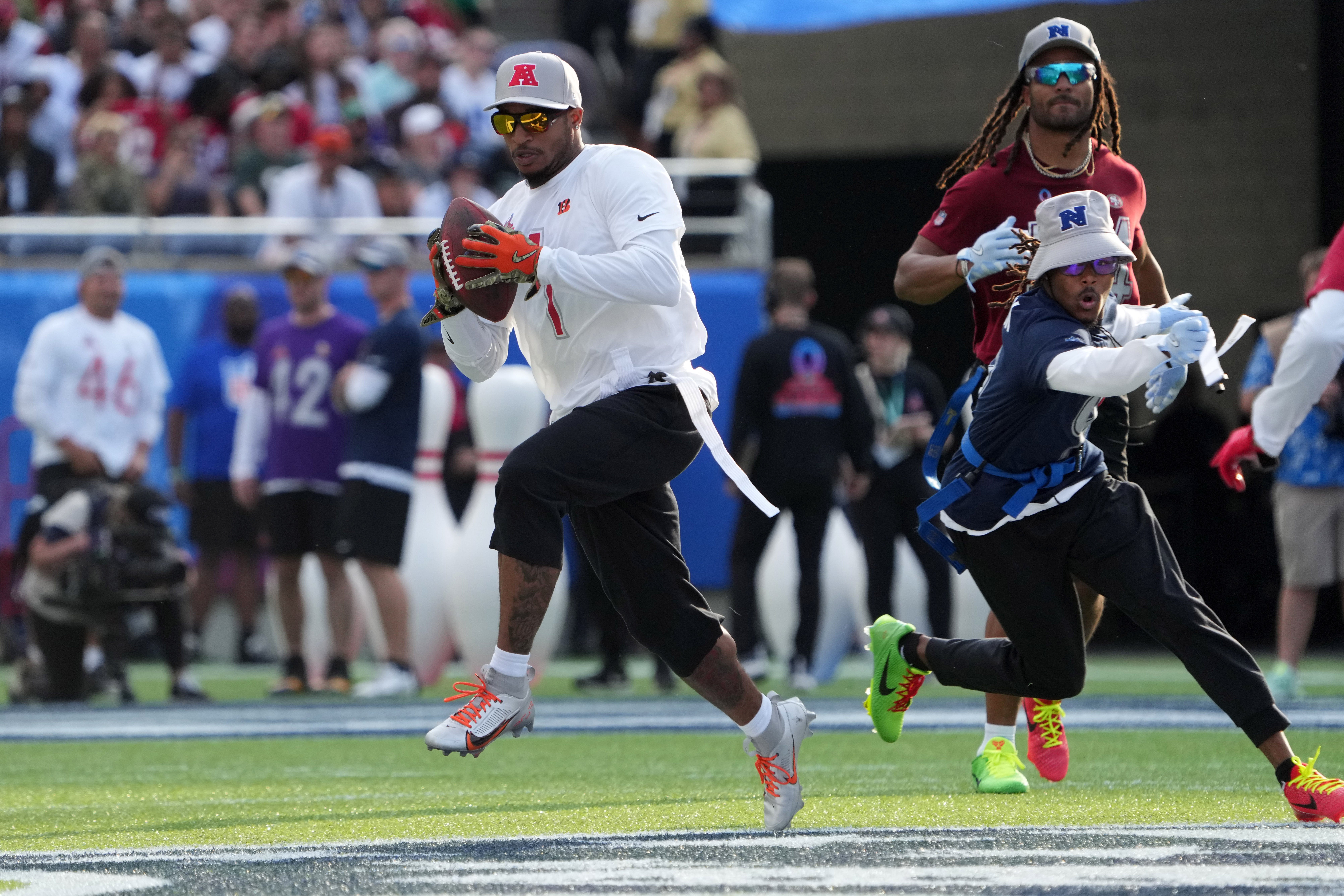 Feb 2, 2025; Orlando, FL, USA; AFC wide receiver Ja'Marr Chase of the Cincinnatti Bengals (1) catches the ball against NFC return specialist KaVontae Turpin of the Dallas Cowboys (9)during the 2025 Pro Bowl Games at Camping World Stadium.