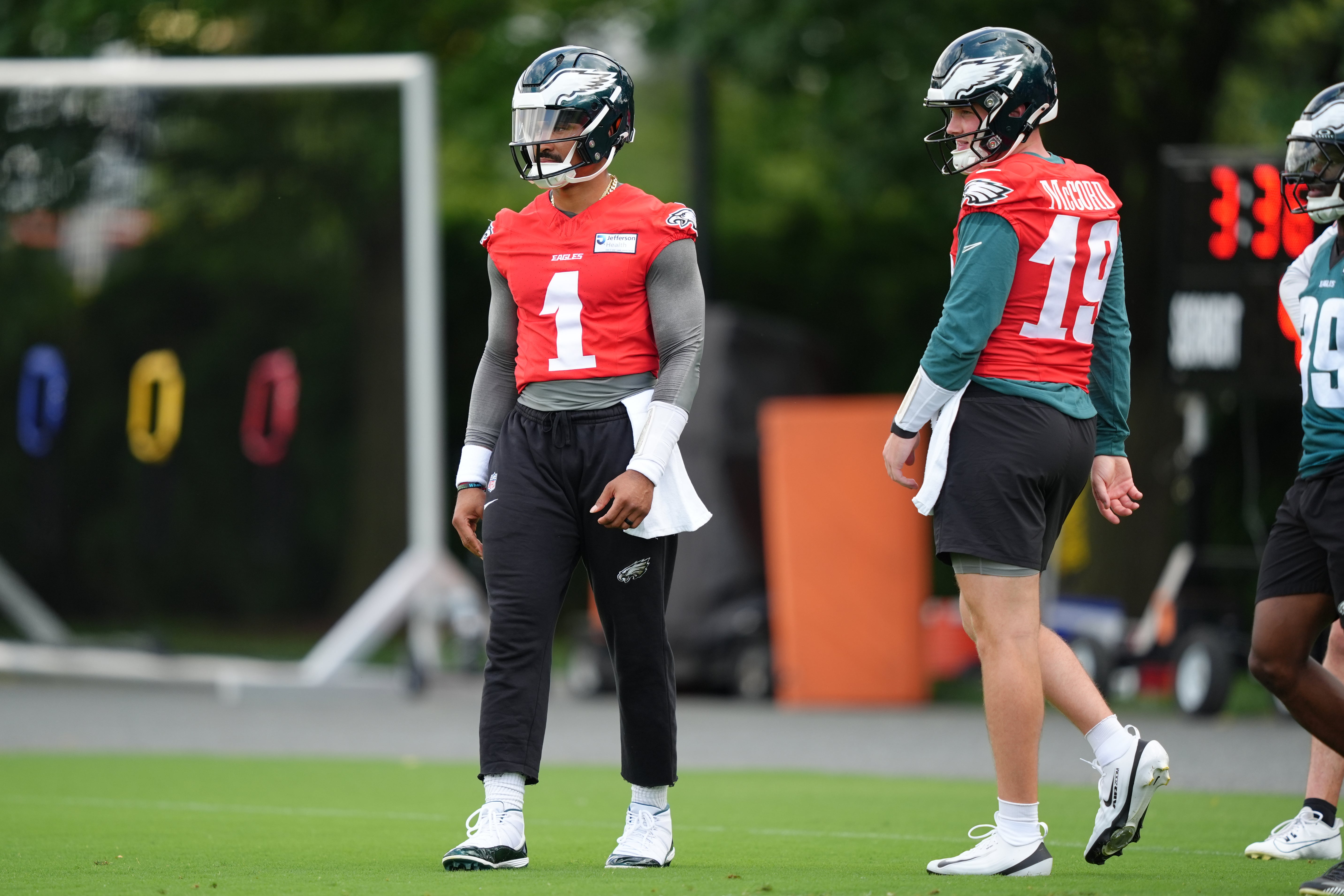 Philadelphia Eagles quarterback Jalen Hurts (1) looks on with quarterback Kyle McCord during a practice drill at NovaCare Complex.