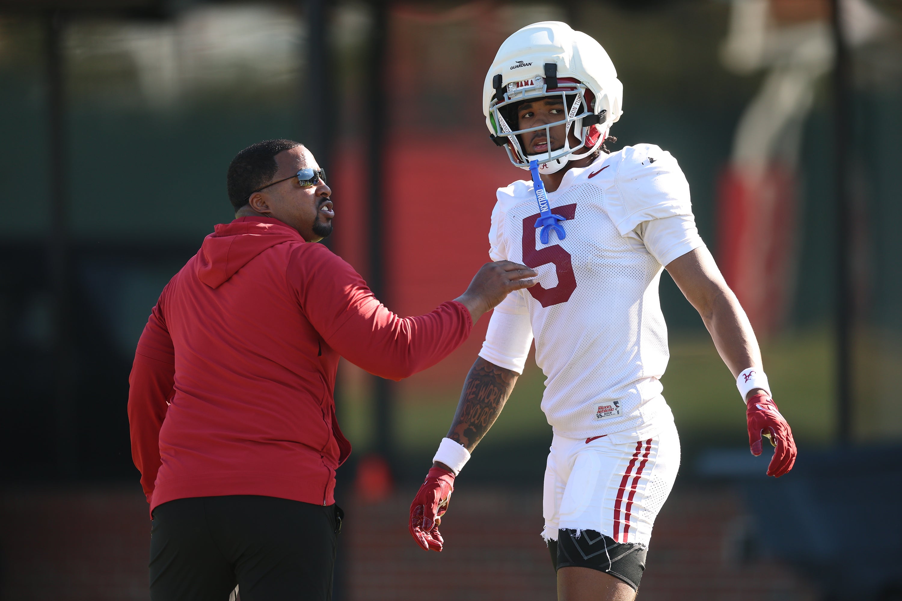 Alabama freshman cornerback Dijon Lee talks things over with defensive backs coach Mo Linguist at the Crimson Tide's spring practice. Photo credit: Alabama Athletics