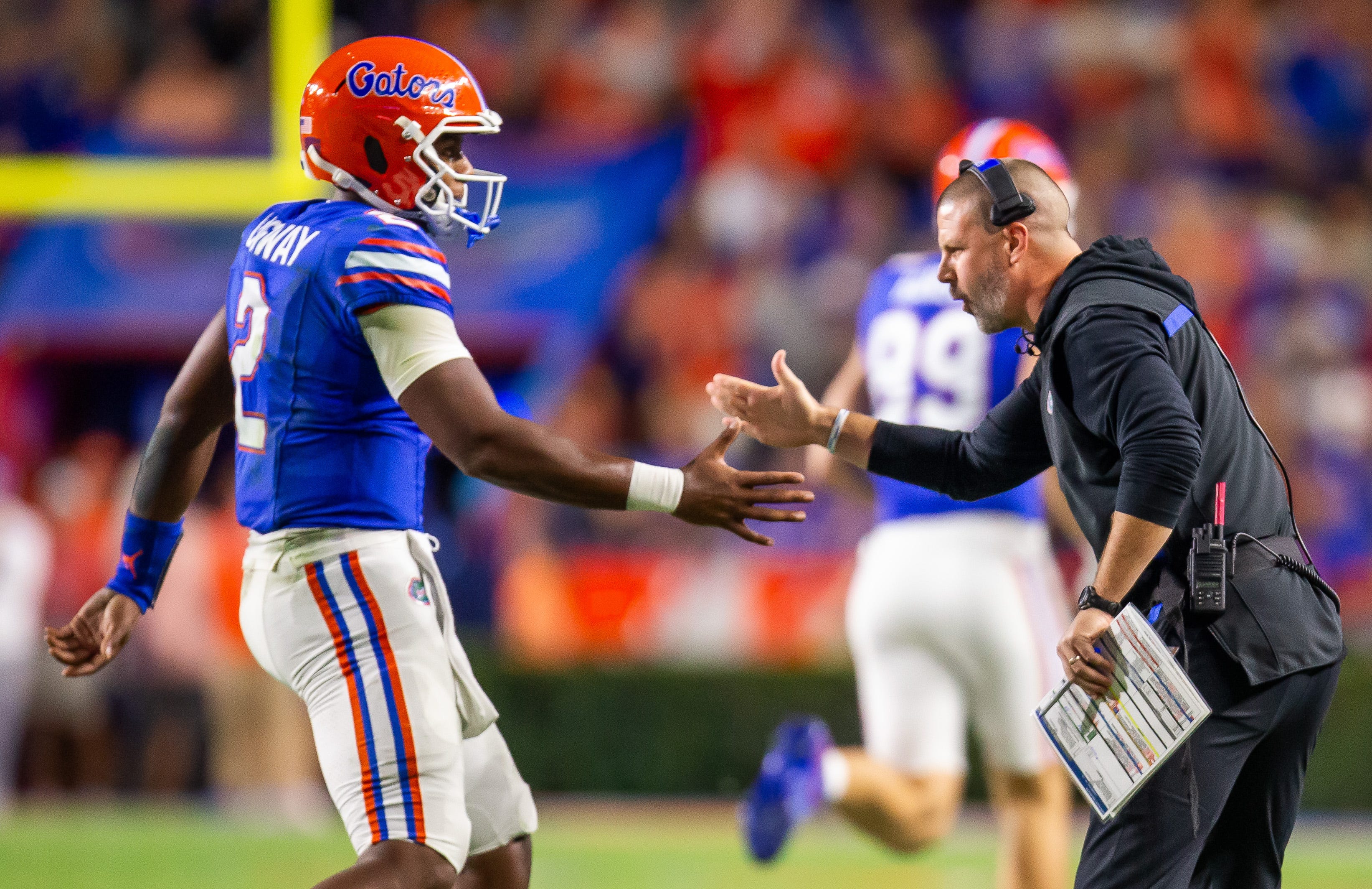 Florida Gators quarterback DJ Lagway (2) is congratulated by Florida Gators head coach Billy Napier after a series during the first half at Ben Hill Griffin Stadium in Gainesville, FL on Saturday, October 19, 2024 against the Kentucky Wildcats.