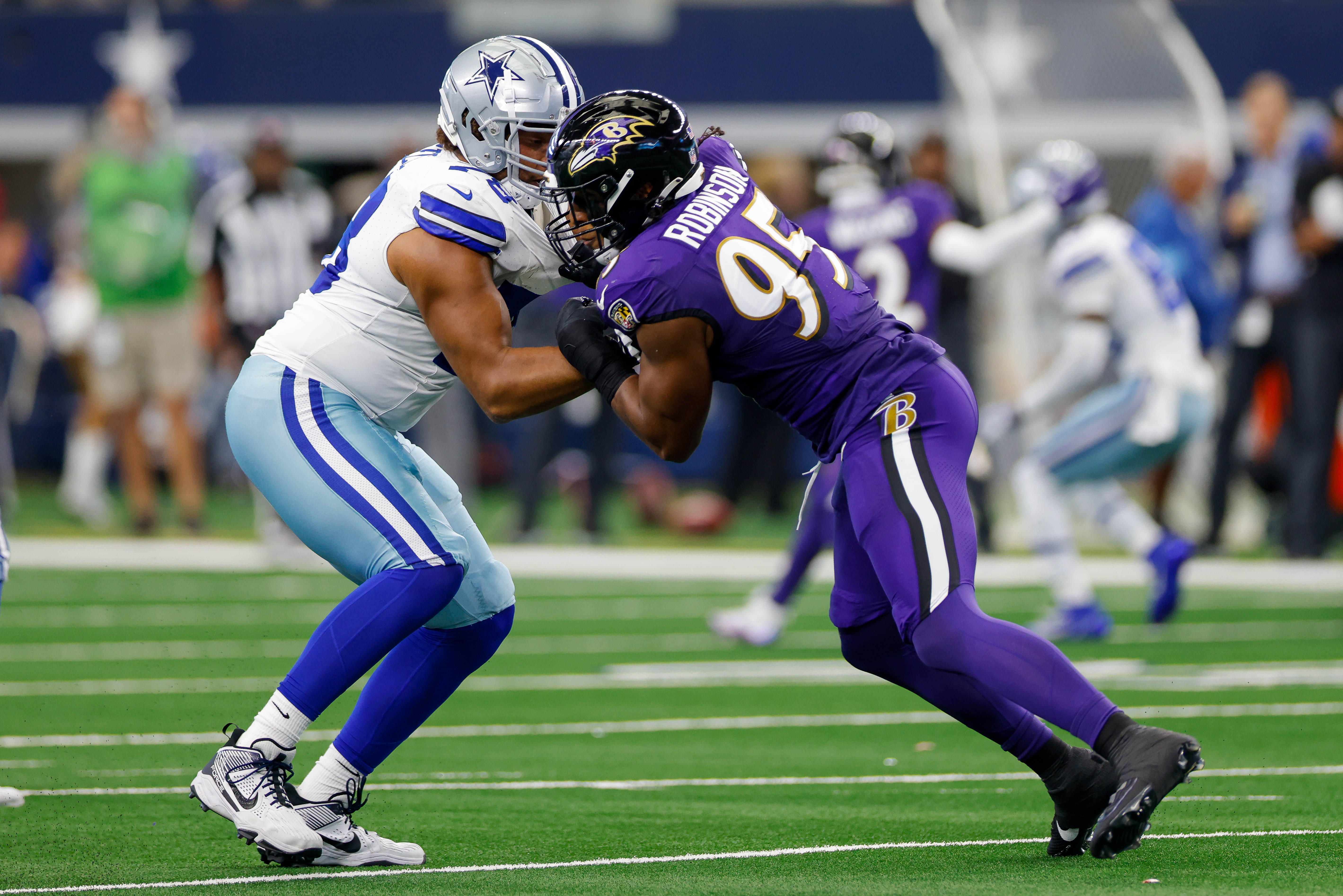 Dallas Cowboys offensive tackle Terence Steele (78) and Baltimore Ravens linebacker Tavius Robinson (95) battle during the first quarter at AT&T Stadium.