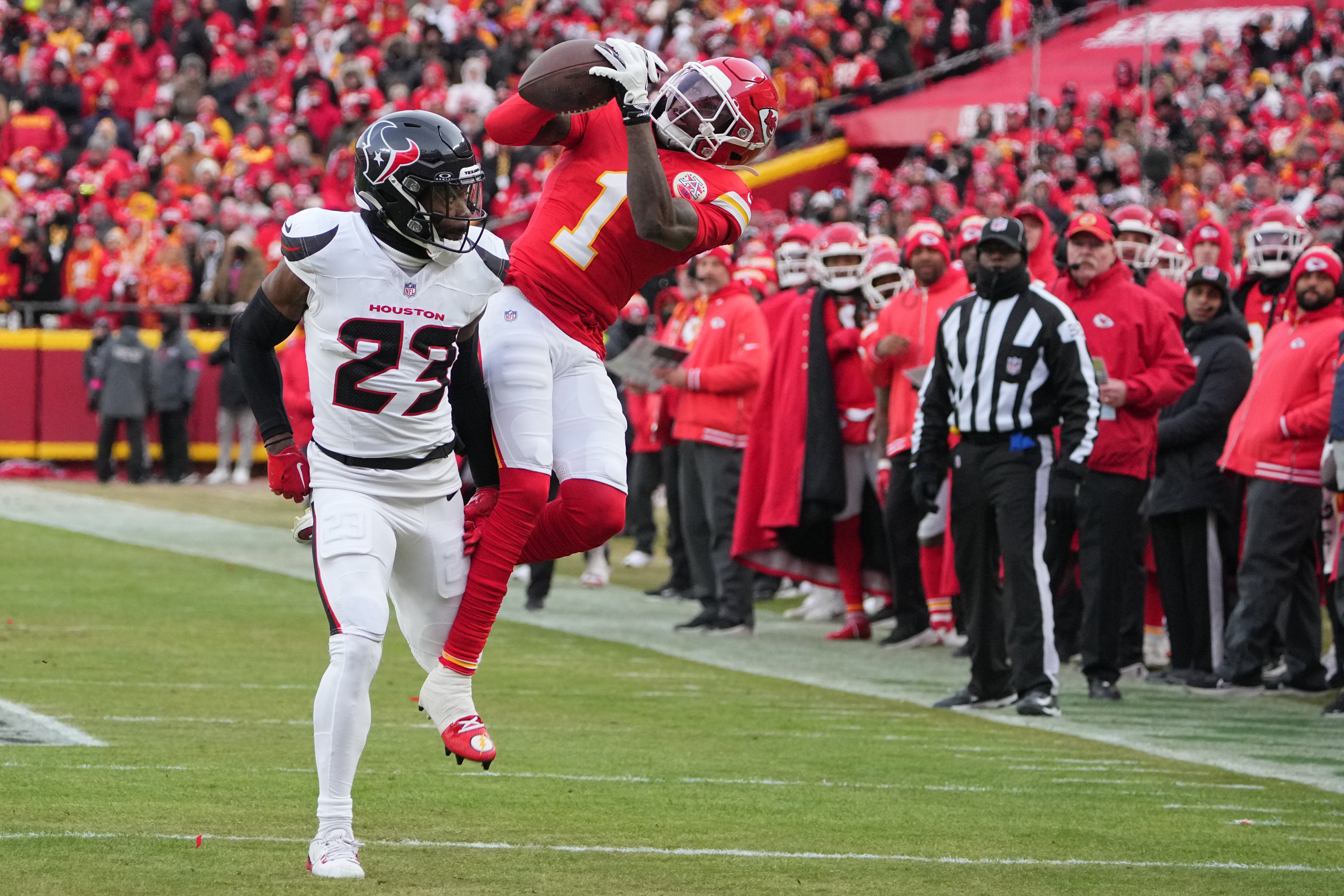 Kansas City Chiefs wide receiver Xavier Worthy (1) makes a catch against Houston Texans safety Eric Murray (23) during the first quarter of a 2025 AFC divisional round game at GEHA Field at Arrowhead Stadium.