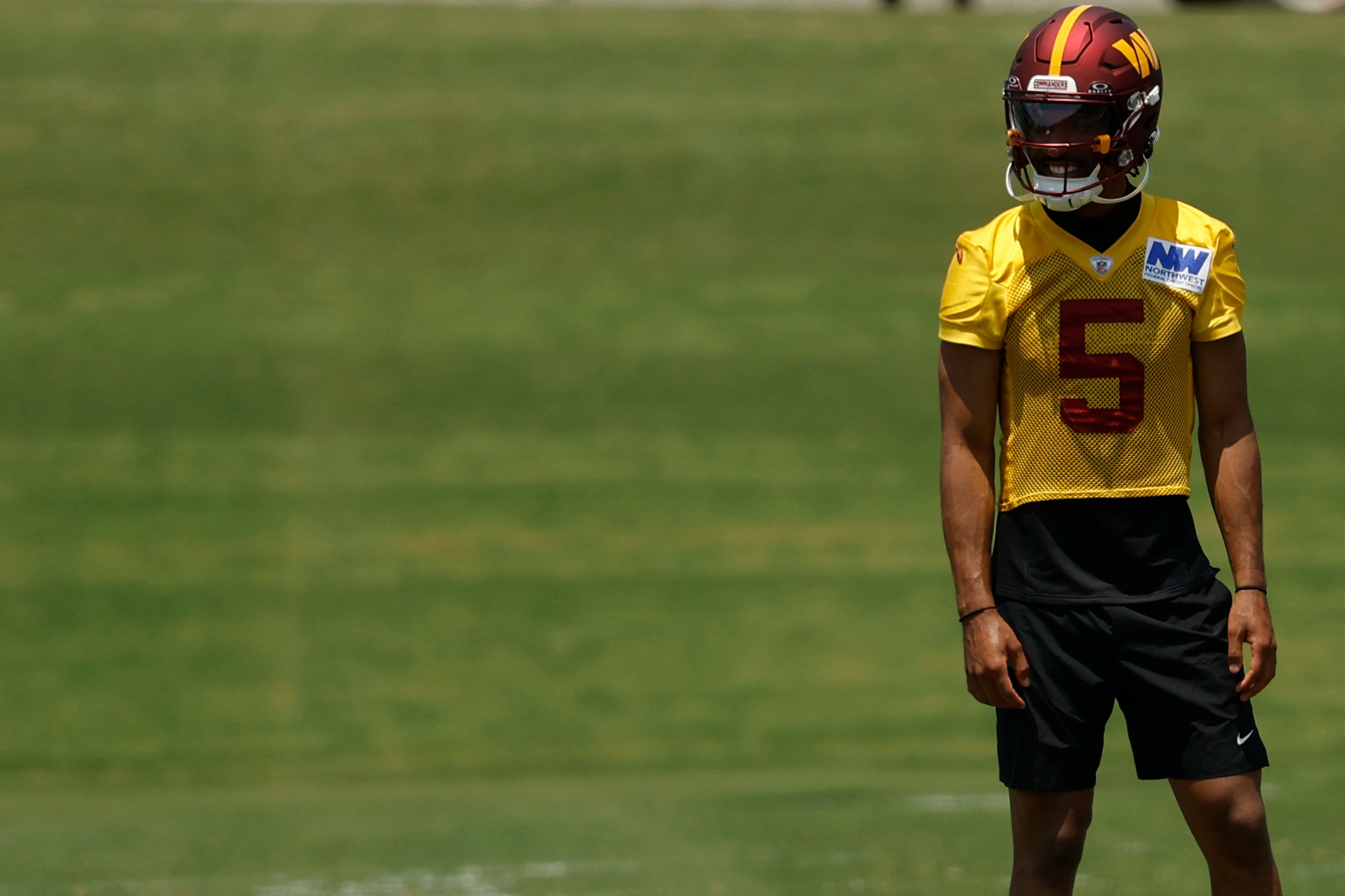 Jun 10, 2025; Ashburn, VA, USA; Washington Commanders quarterback Jayden Daniels (5) stands on the field between drills on day one of minicamp at Commanders Park.