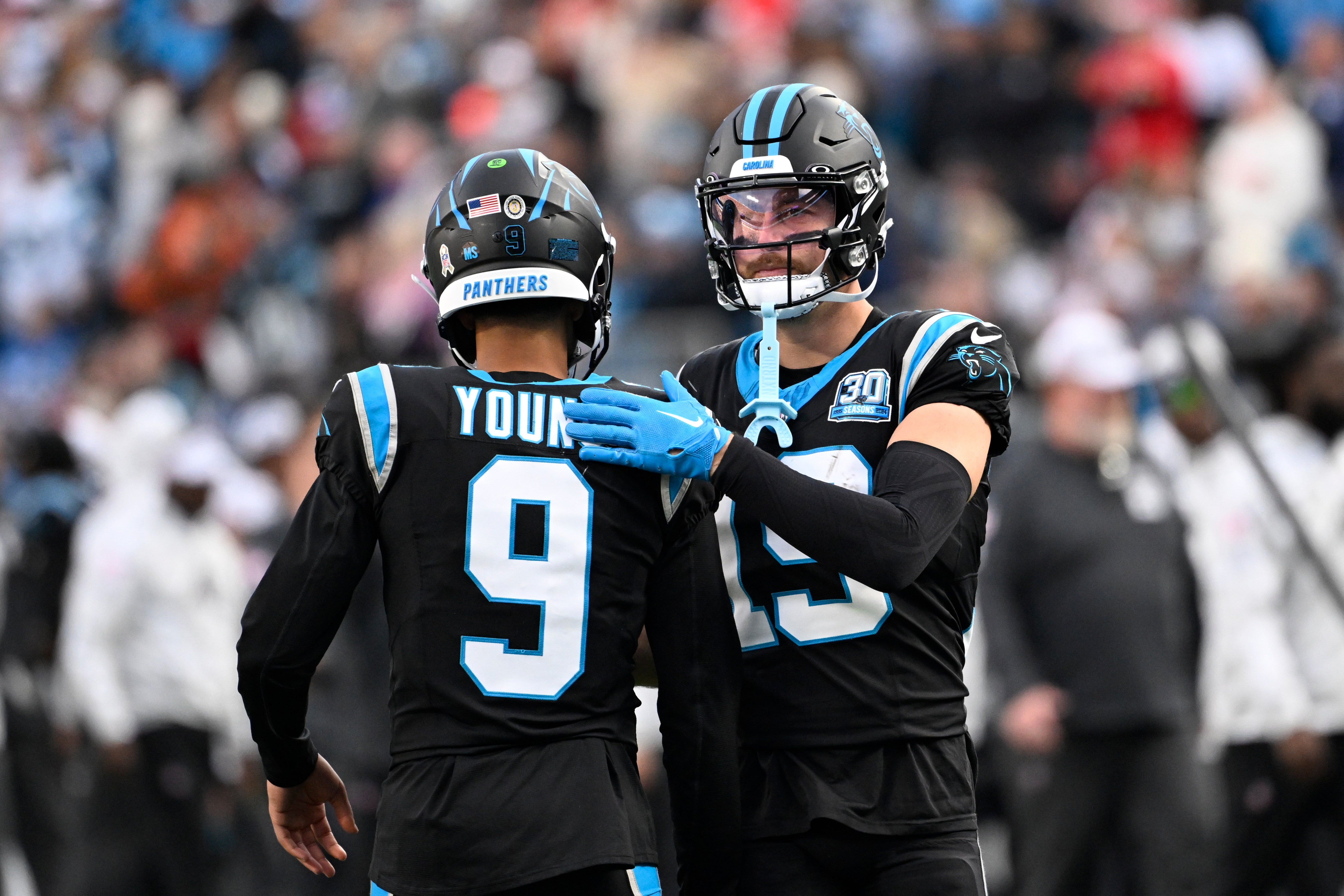 Nov 24, 2024; Charlotte, North Carolina, USA; Carolina Panthers quarterback Bryce Young (9) with wide receiver Adam Thielen (19) on the field in the fourth quarter at Bank of America Stadium.