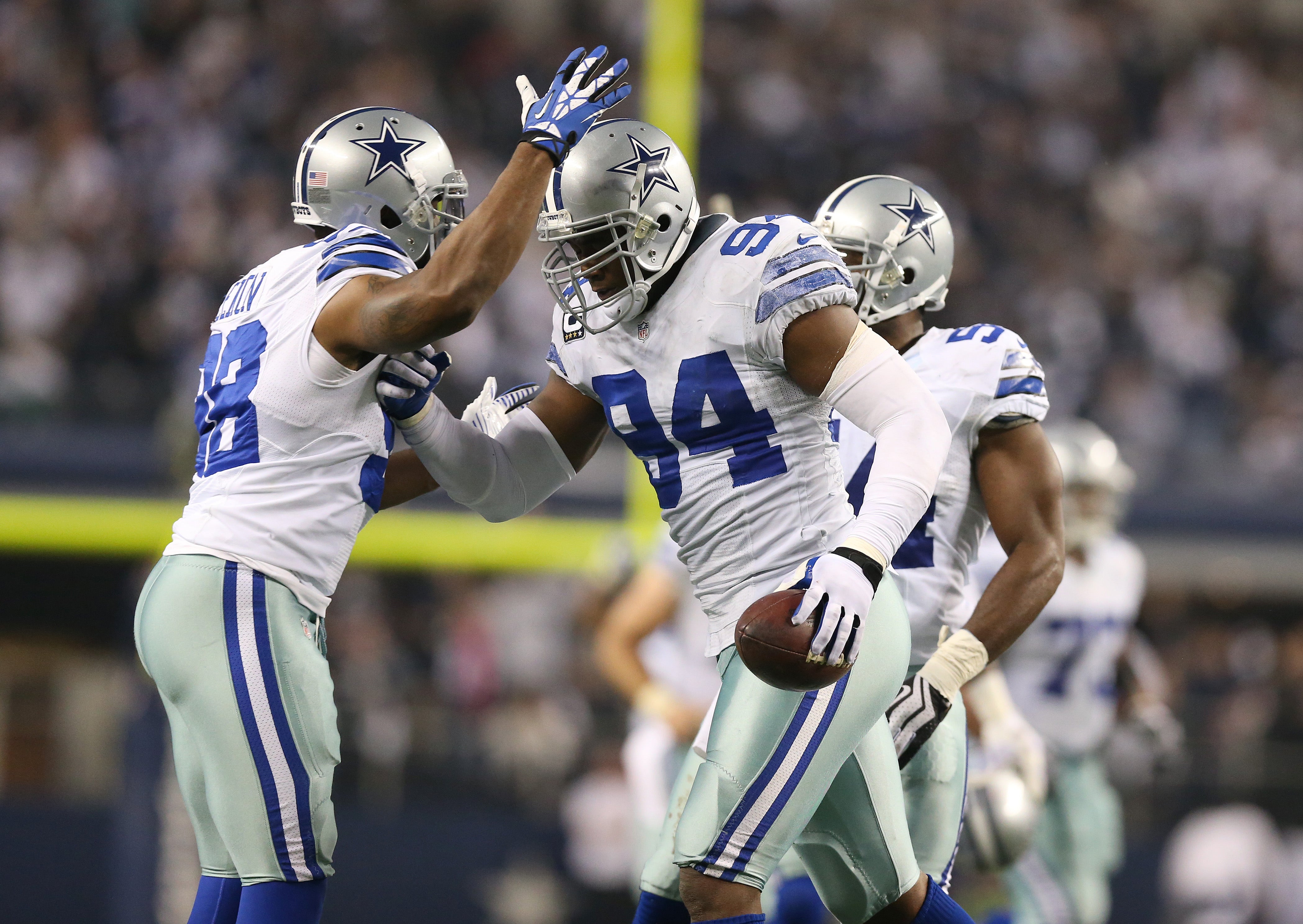 Dallas Cowboys defensive end DeMarcus Ware (94) celebrates after recovering a fumble with linebacker Trent Cole (58) in the third quarter against the Philadelphia Eagles at AT&T Stadium.