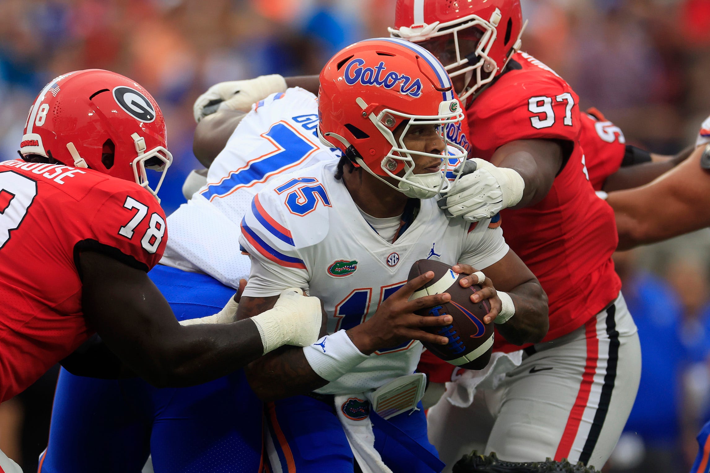 Florida Gators quarterback Anthony Richardson (15) is pressured by Georgia Bulldogs defensive lineman Warren Brinson (97) and defensive lineman Nazir Stackhouse (78) during the second quarter of an NCAA football game Saturday, Oct. 29, 2022 at TIAA Bank Field in Jacksonville. The Georgia Bulldogs outlasted the Florida Gators 42-20.