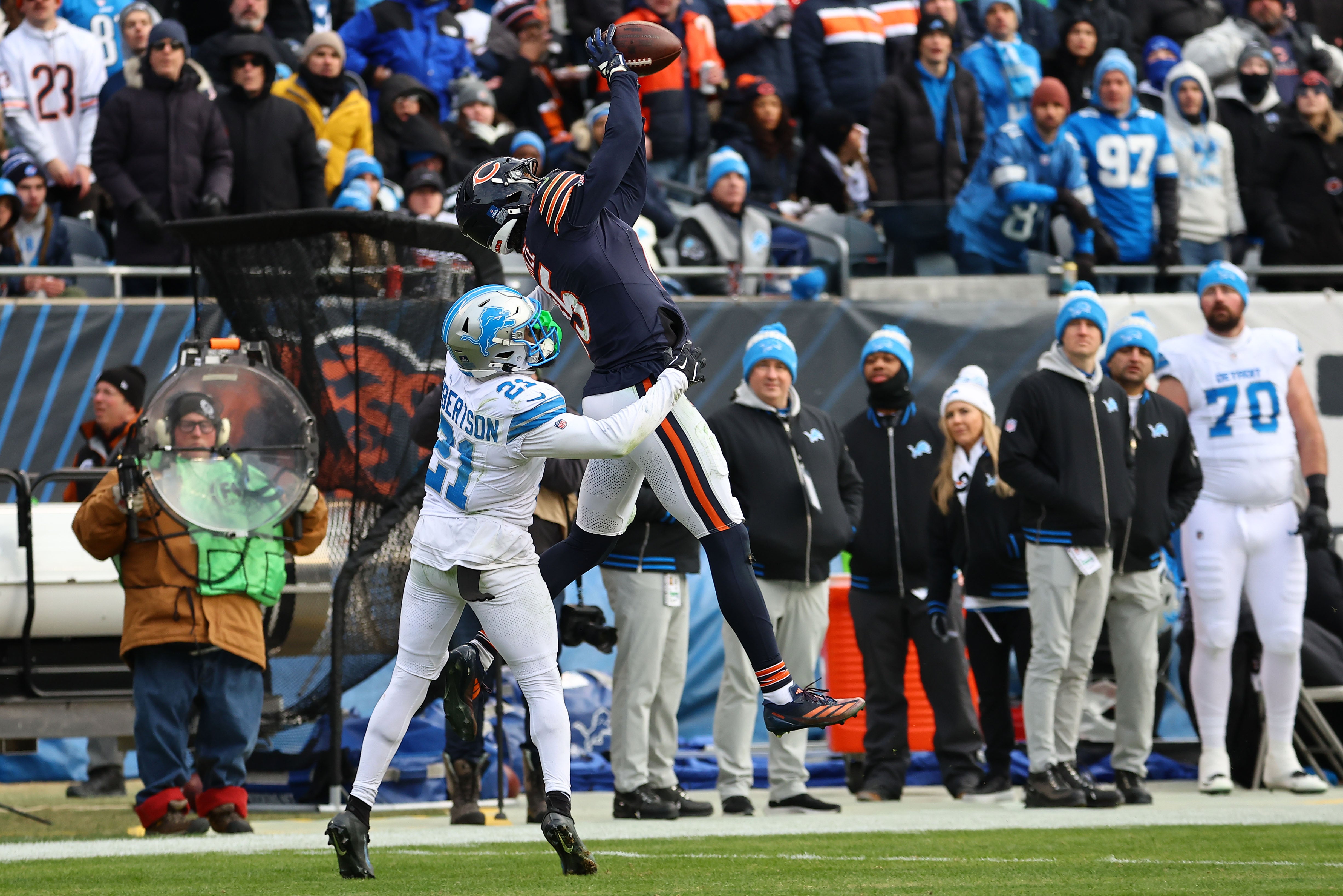 Dec 22, 2024; Chicago, Illinois, USA; Chicago Bears wide receiver Rome Odunze (15) makes a catch over Detroit Lions cornerback Amik Robertson (21) during the second half at Soldier Field.