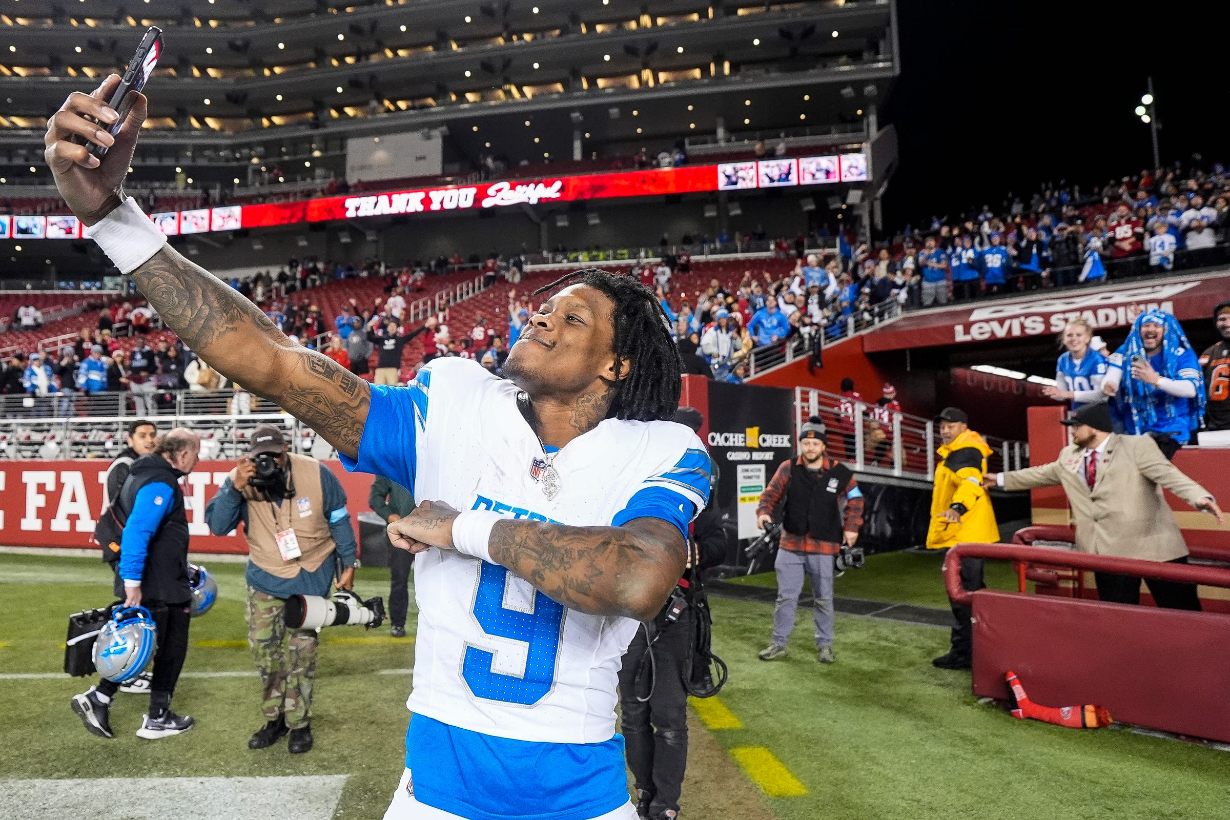 Detroit Lions wide receiver Jameson Williams takes a selfie to celebrate the 40-34 win over the San Francisco 49ers as he exits the field at Levi's Stadium in Santa Clara, Calif. on Monday, Dec. 30, 2024.