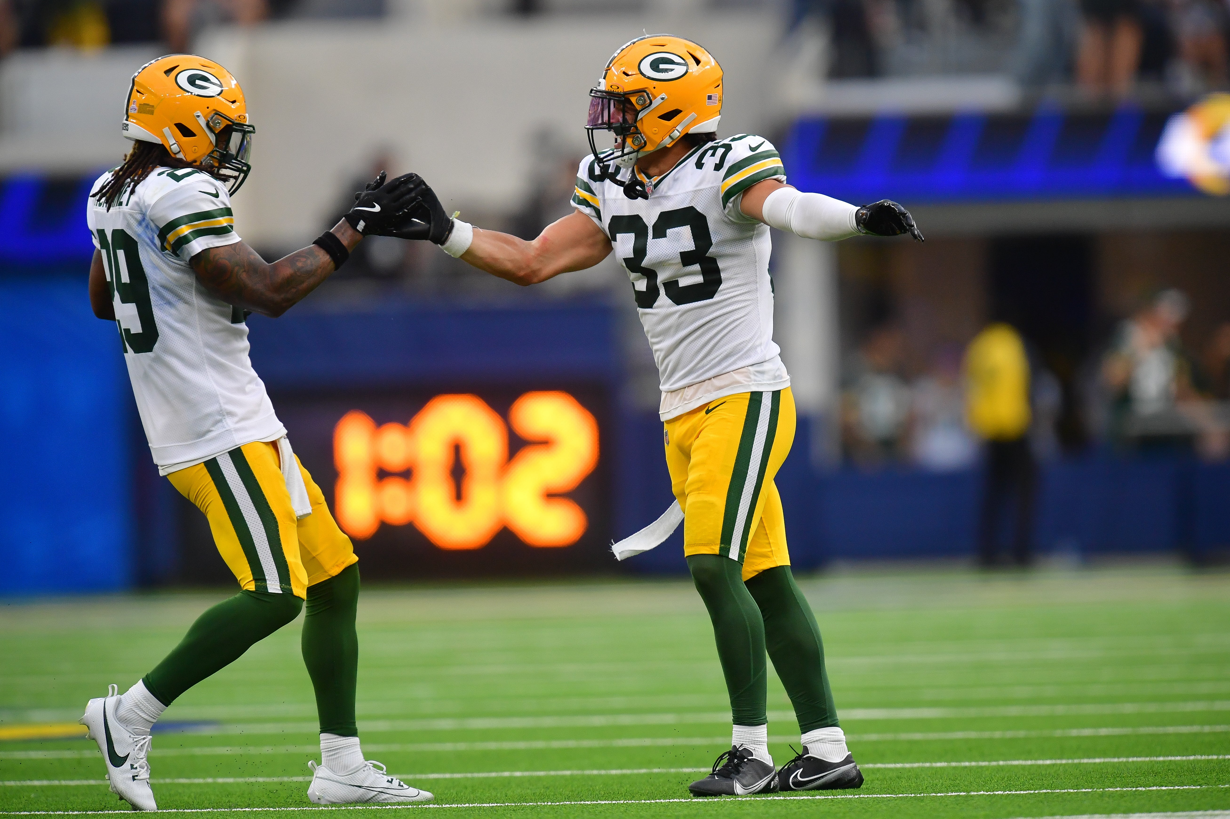 Green Bay Packers safety Evan Williams (33) and safety Xavier McKinney (29) react after stopping the Los Angeles Rams on fourth down during the second half at SoFi Stadium.