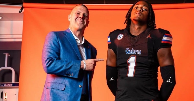 2026 four-star EDGE K.J. Ford posing with Florida Gators head coach Billy Napier during a visit to campus.