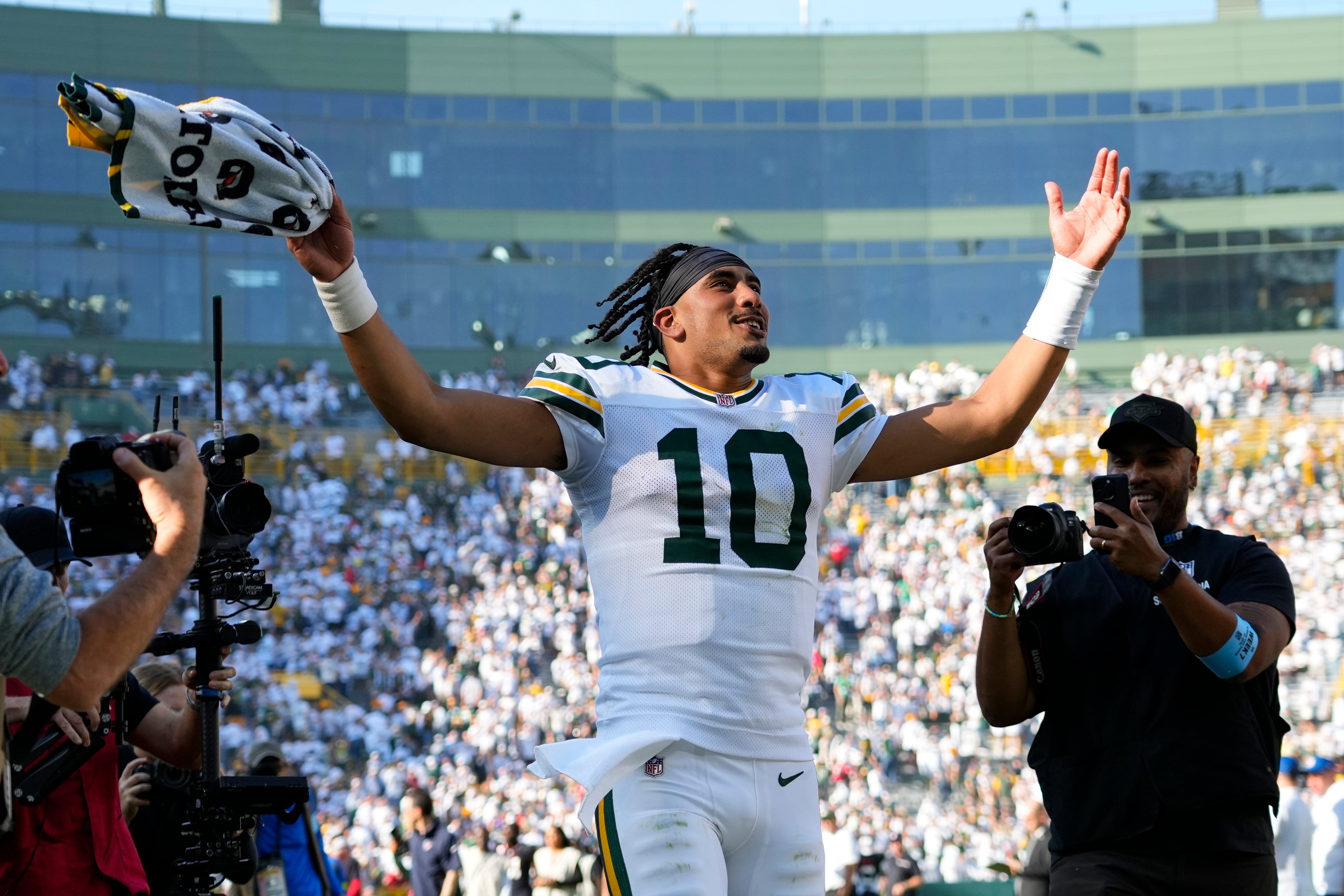 Green Bay Packers quarterback Jordan Love (10) celebrates as he runs off the field following the game against the Houston Texans at Lambeau Field. 