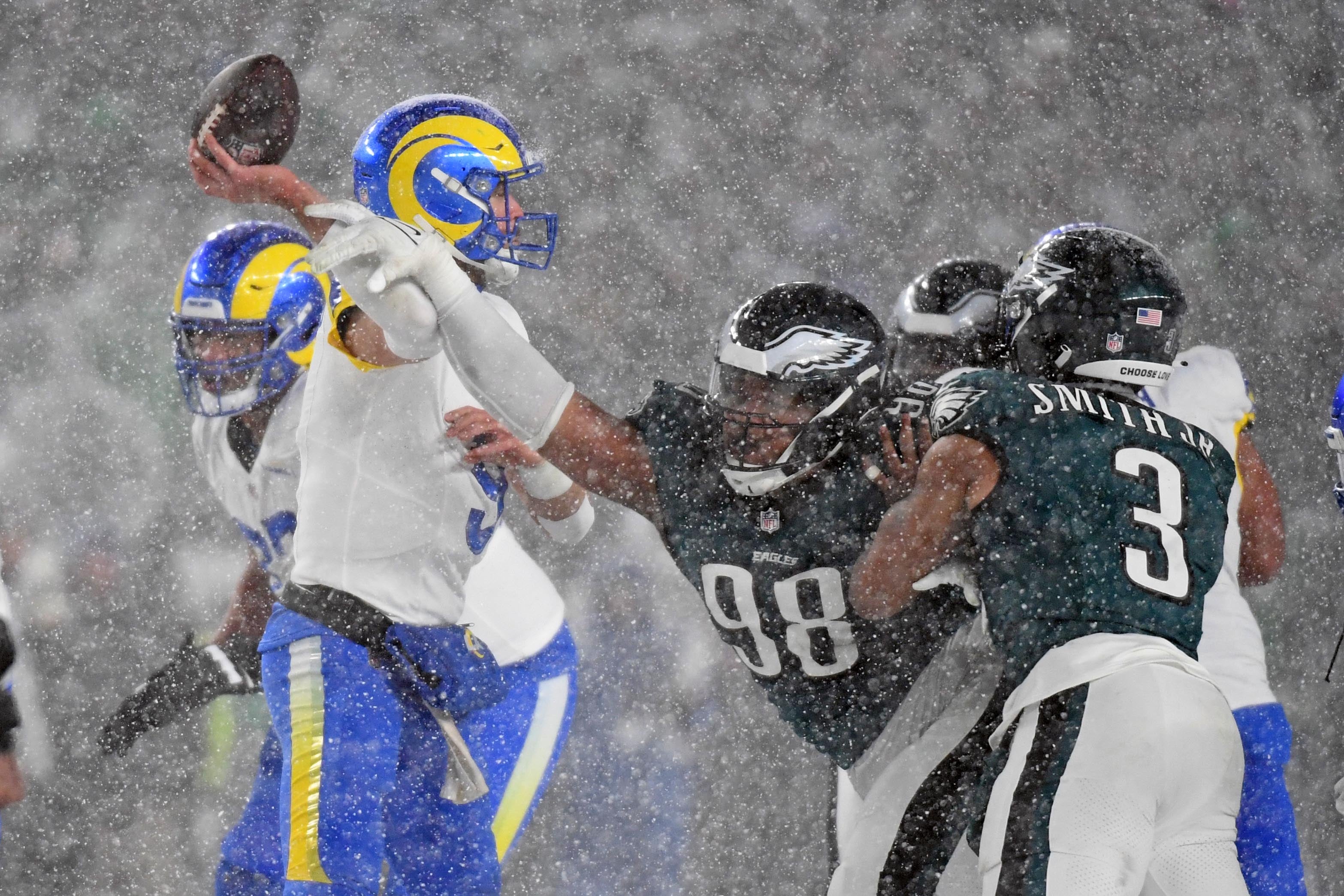 Los Angeles Rams quarterback Matthew Stafford (9) is pressured by Philadelphia Eagles defensive tackle Jalen Carter (98) during the fourth quarter in a 2025 NFC divisional round game at Lincoln Financial Field.