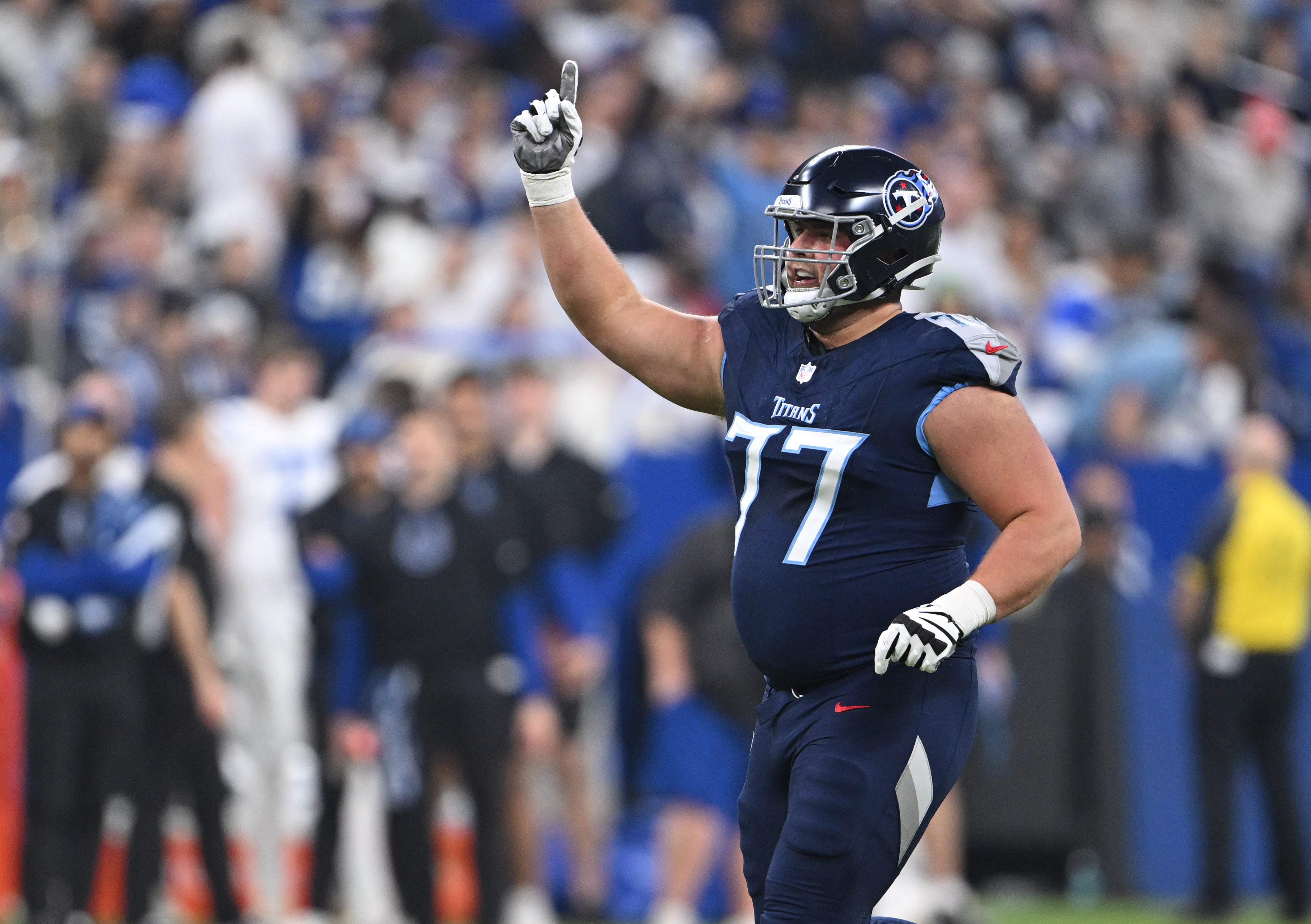 Dec 22, 2024; Indianapolis, Indiana, USA; Tennessee Titans offensive tackle Peter Skoronski (77) celebrates a touchdown during the first quarter against the Indianapolis Colts at Lucas Oil Stadium. Mandatory Credit: Marc Lebryk-Imagn Images