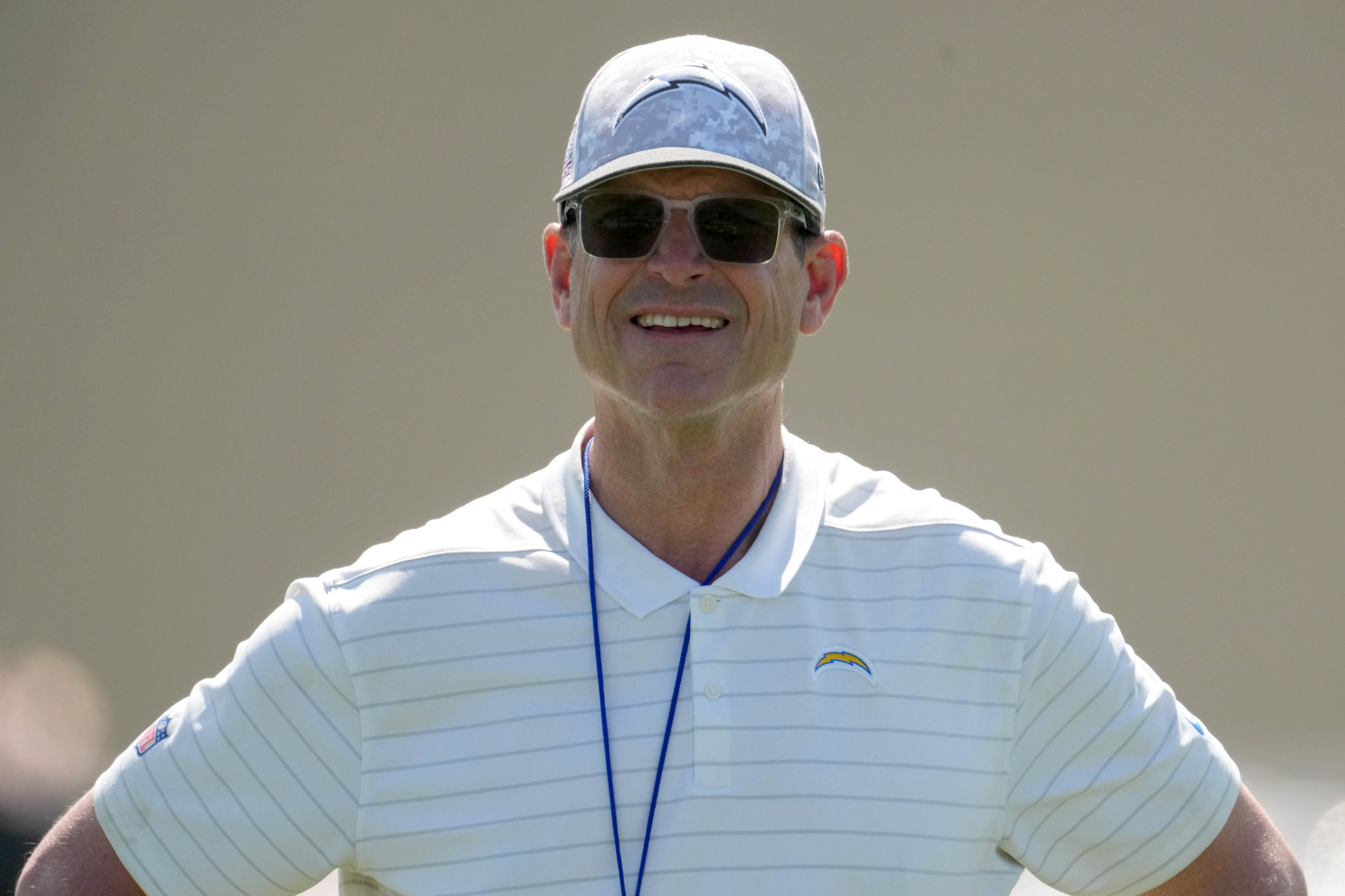 May 20, 2025; El Segundo, CA, USA; Los Angeles Chargers coach Jim Harbaugh looks on during offseason workouts at The Bolt.