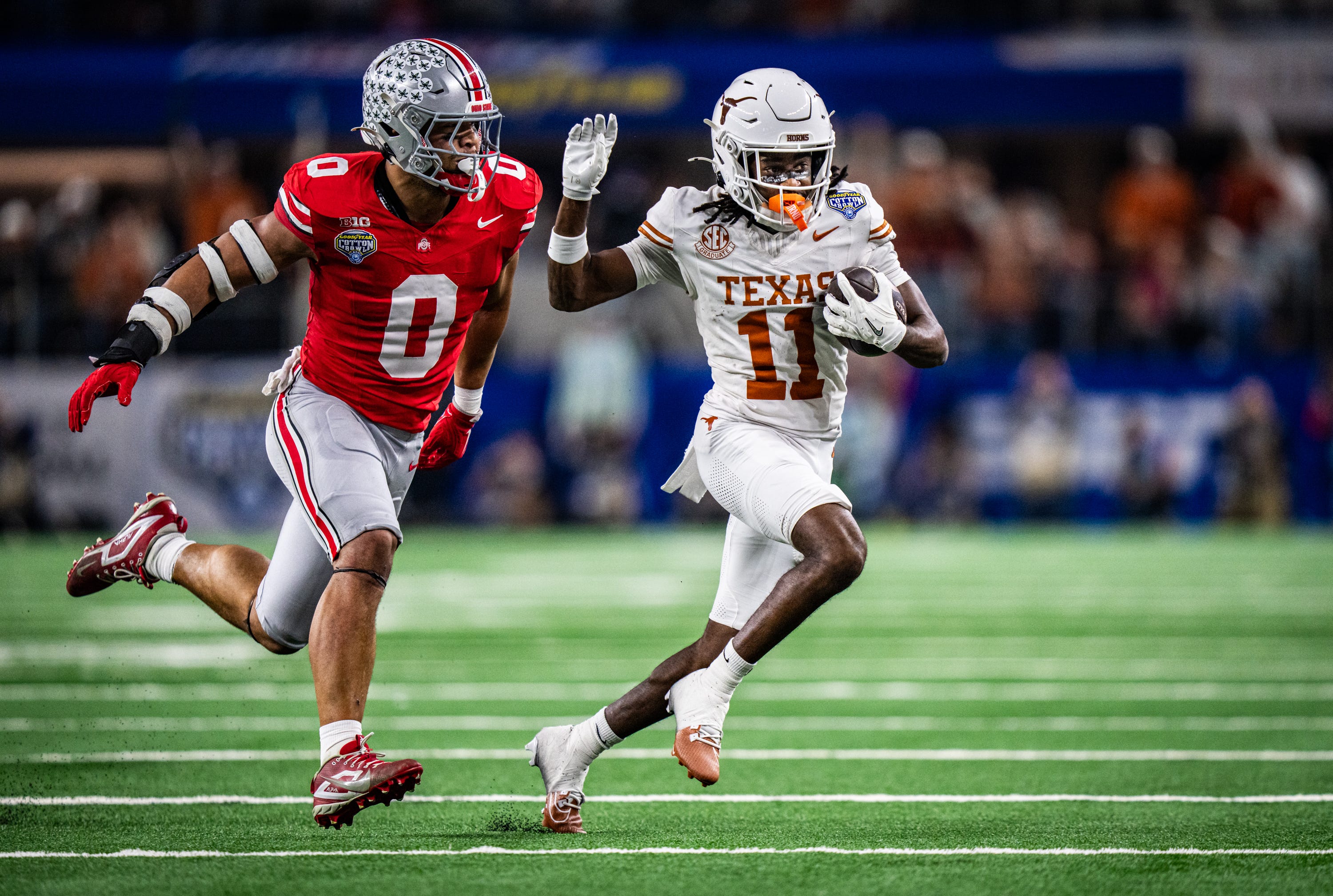 Texas Longhorns wide receiver Silas Bolden (11) runs the ball as Ohio State Buckeyes linebacker Cody Simon (0) runs to defend in the second quarter as the Texas Longhorns play the Ohio State Buckeyes in the Cotton Bowl College Football Playoff semi-final at AT&T Stadium in Dallas, Texas, Jan. 10, 2025.