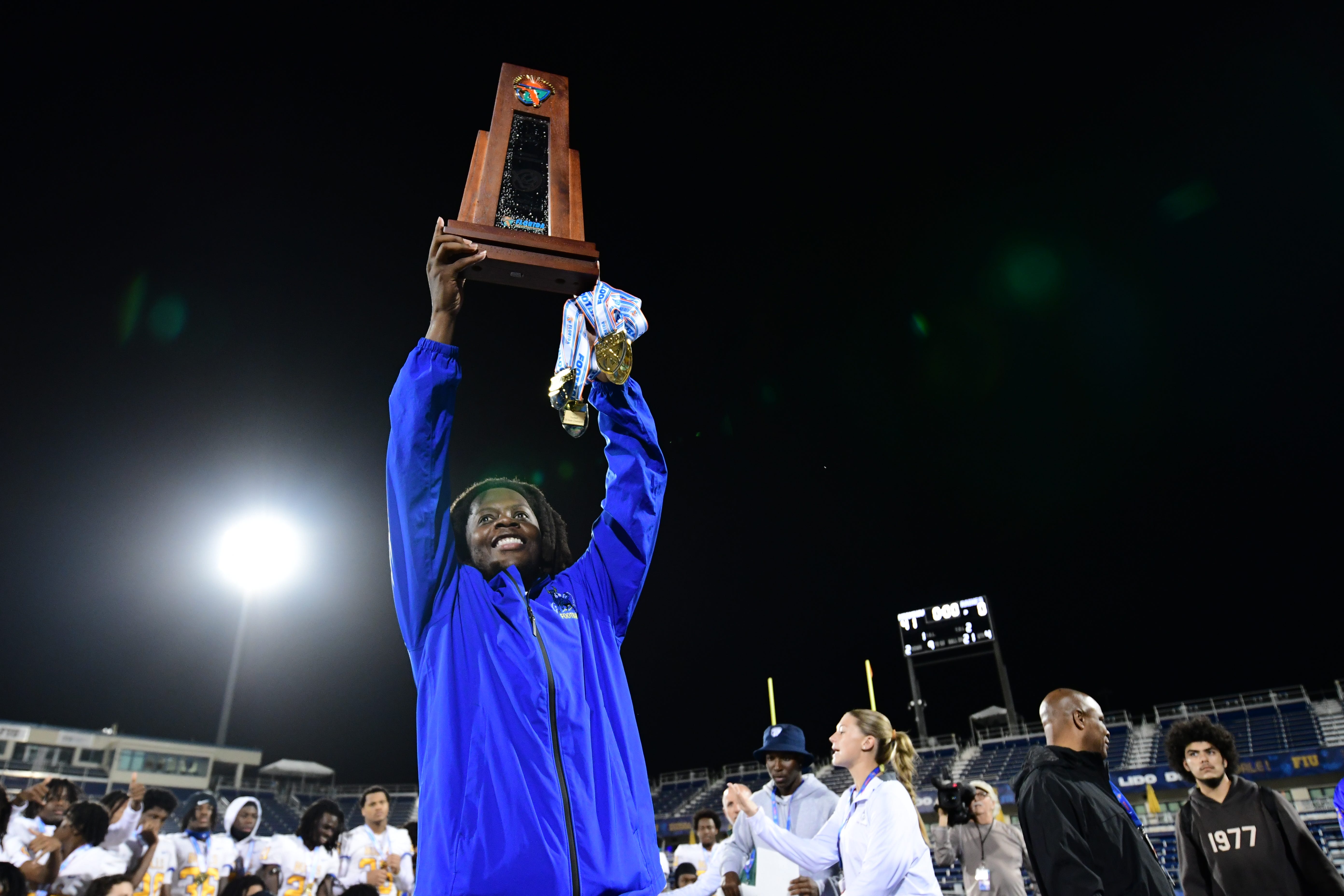 Miami Northwestern's Teddy Bridgewater raises the state trophy following the team's win over Raines in the Class 3A championship on Dec. 14, 2024.