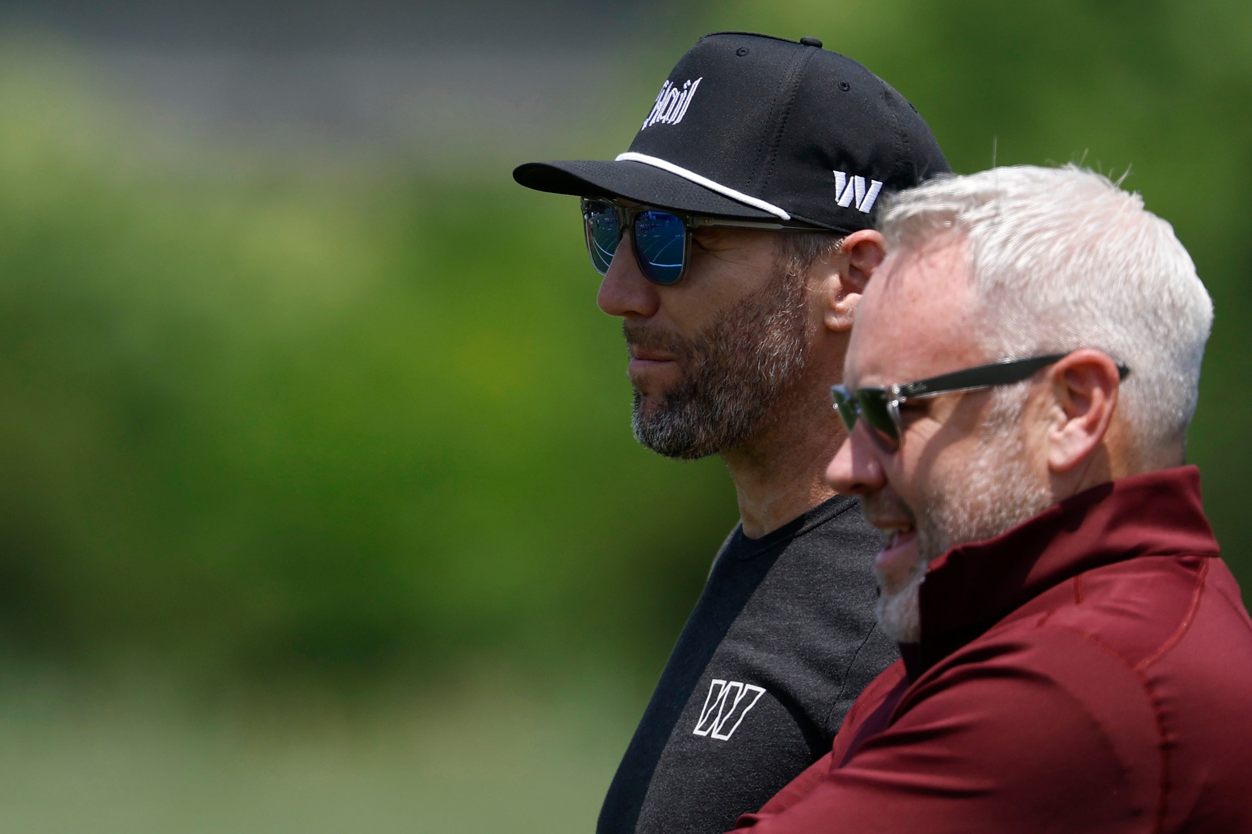 Jun 10, 2025; Ashburn, VA, USA; Washington Commanders general manager Adam Peters (L) and assistant general manager Lance Newmark (R) look on during day one of minicamp at Commanders Park.