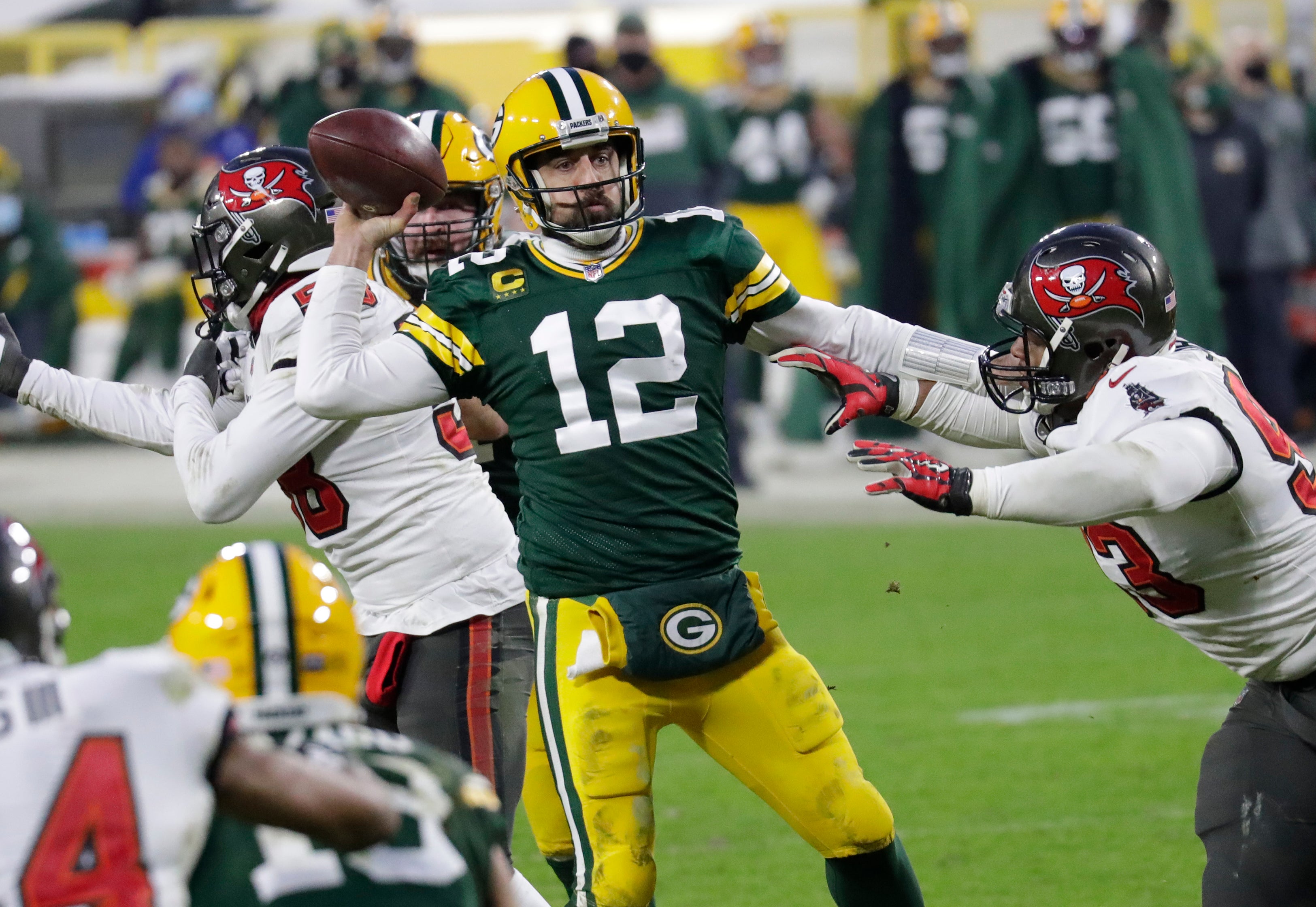 Green Bay Packers quarterback Aaron Rodgers (12) throws an inccomplete pass against Tampa Bay Buccaneers defensive end Ndamukong Suh (93) in the final minutes of the game during the NFC championship game Sunday, January 24, 2021, at Lambeau Field