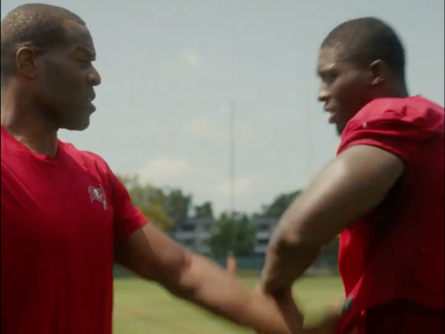 Yaya Diaby learns some techniques from Bucs legend Simeon Rice.
