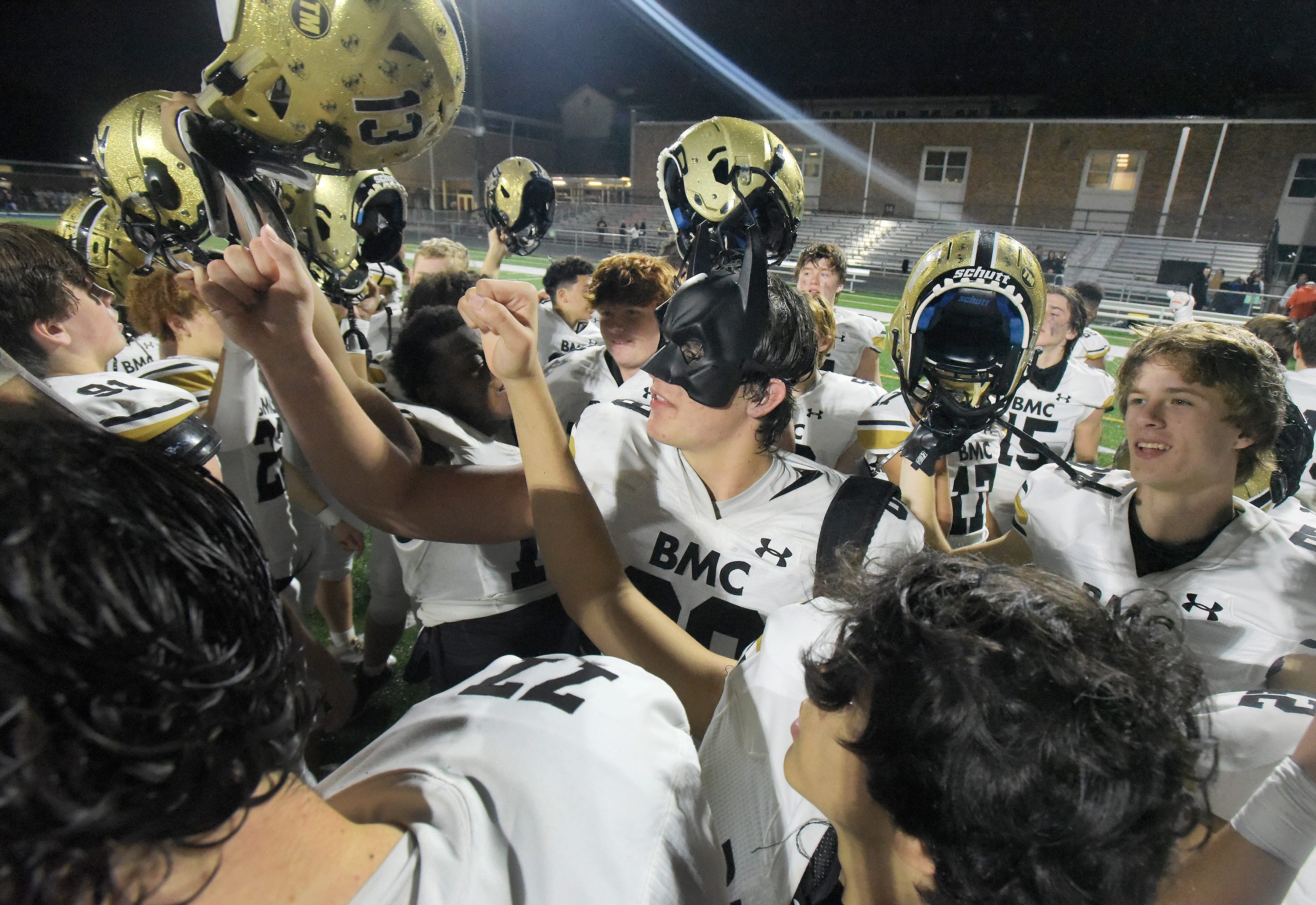Bishop Moore players, including Jake Kreul (88) in his batman mask circle up in celebration after Friday night's 37 to 35 victory over the Riverside Generals. Orlando s Bishop Moore High School traveled to Jacksonville s Riverside High School for the Class 3M football Playoffs Friday, November 17, 2023. The Riverside Generals trailed 22 to 13 at the half and battled back in the second half but fell short, ending their season with a 37 to 35 loss to the Bishop Moore Hornets.