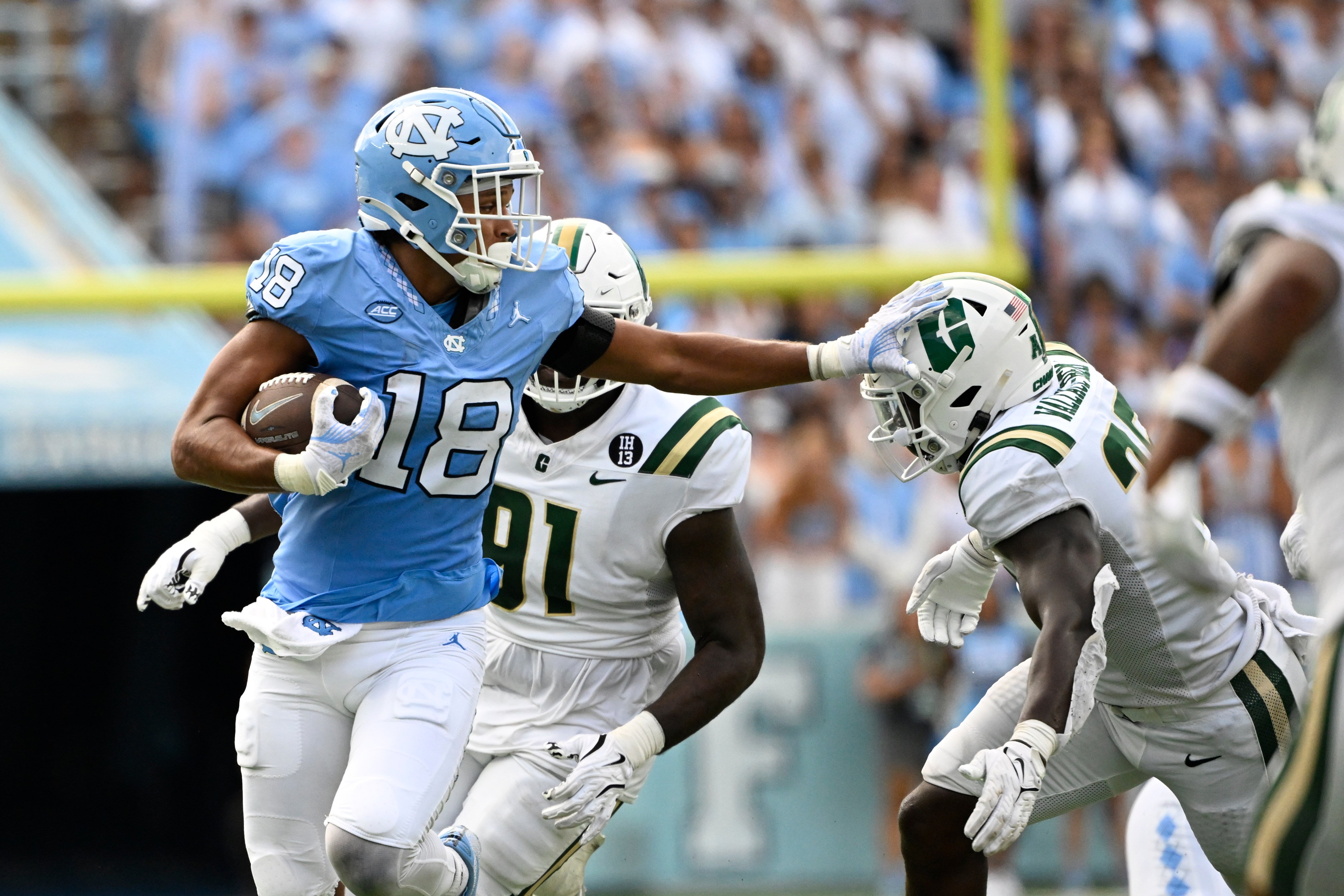 Sep 7, 2024; Chapel Hill, North Carolina, USA; North Carolina Tar Heels tight end Bryson Nesbit (18) with the ball as Charlotte 49ers linebacker Prince Wallace-Bemah (25) defends in the second quarter at Kenan Memorial Stadium.