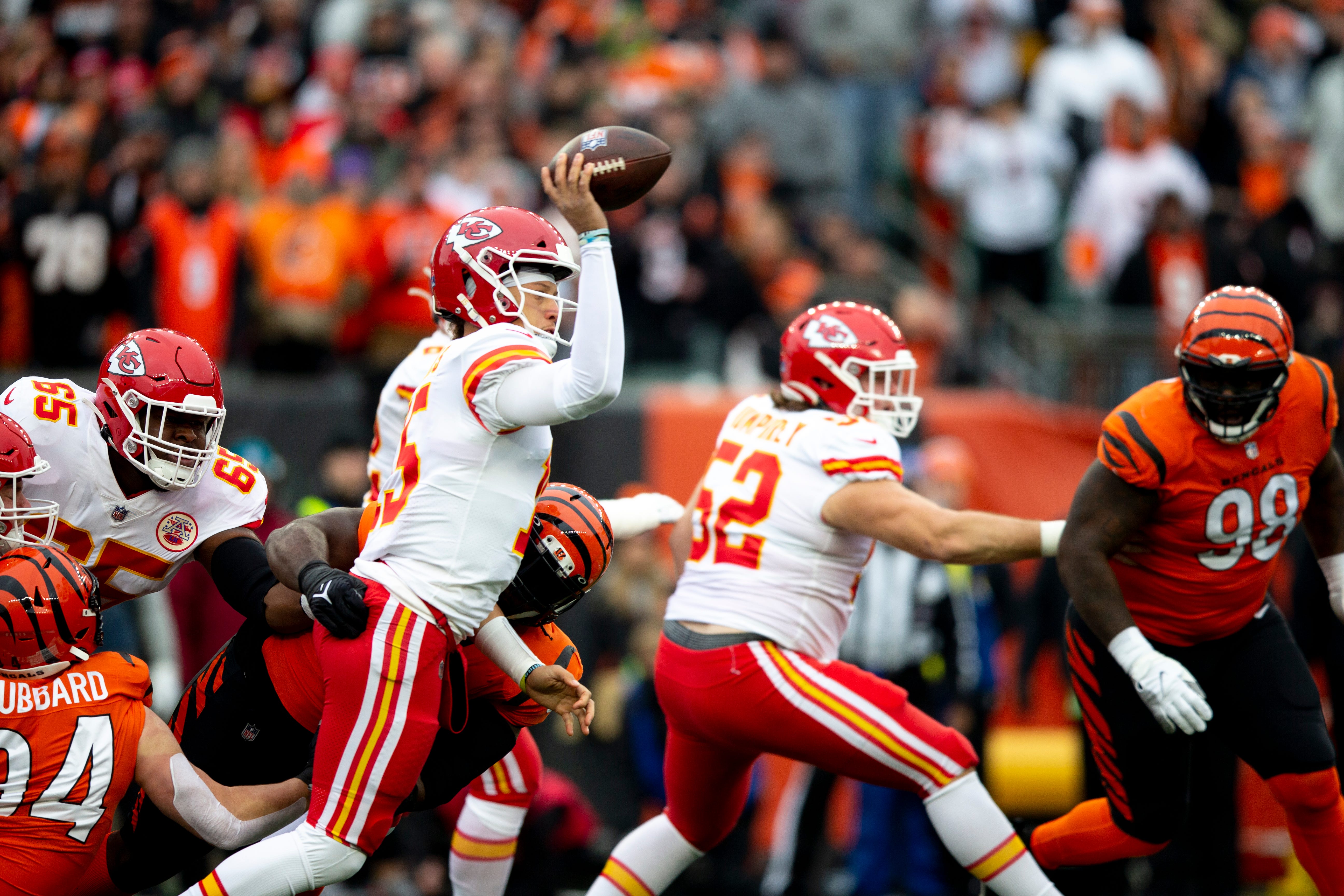 Kansas City Chiefs quarterback Patrick Mahomes (15) completes a pass as he's hit throwing by Kansas City Chiefs guard Trey Smith (65) in the first half of the NFL game between the Cincinnati Bengals and the Kansas City Chiefs on Sunday, Jan. 2, 2022, at Paul Brown Stadium in Cincinnati. Cincinnati Bengals And The Kansas City Chiefs 457