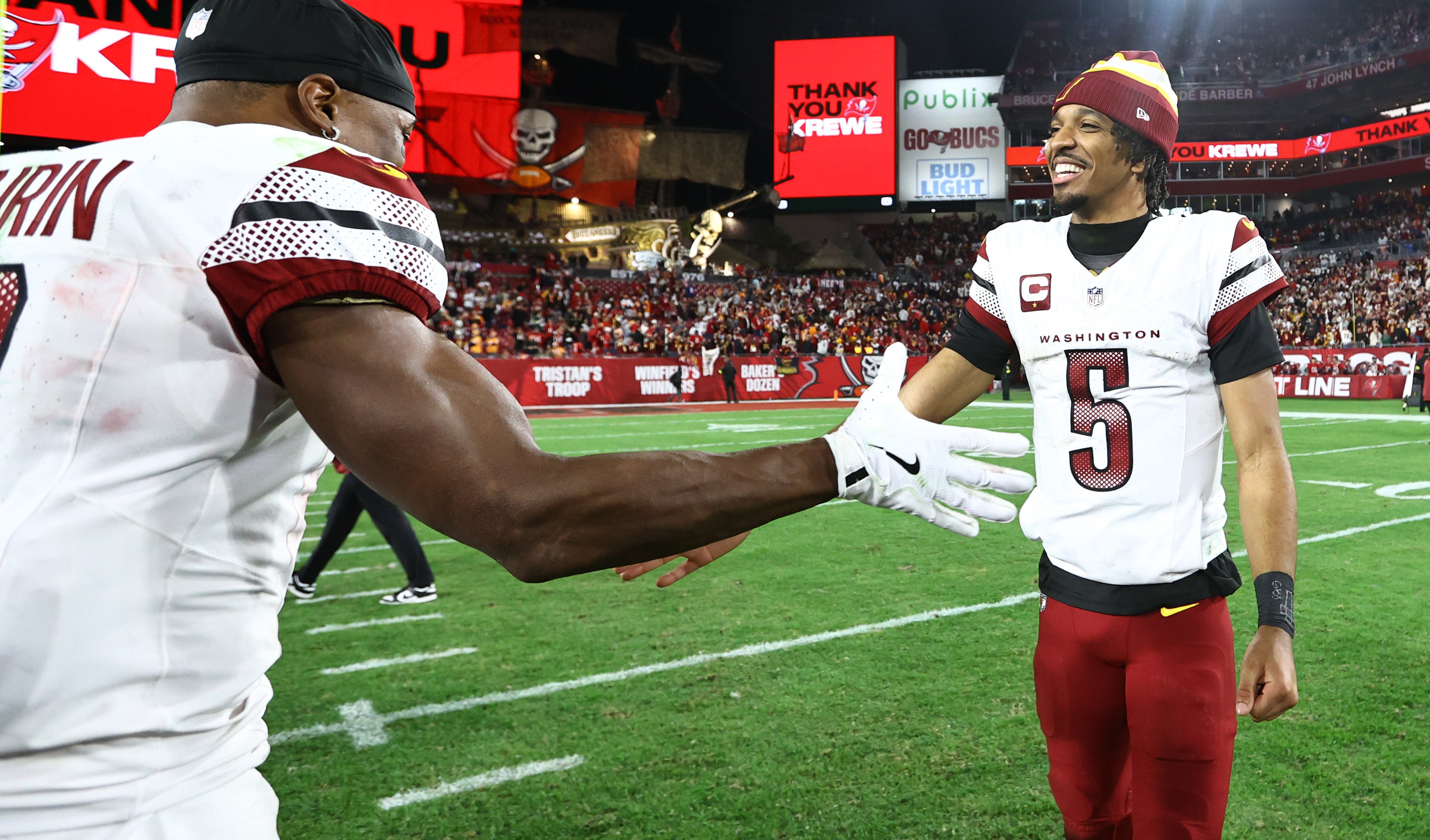Jan 12, 2025; Tampa, Florida, USA; Washington Commanders quarterback Jayden Daniels (5) celebrates with wide receiver Terry McLaurin (17) after winning a NFC wild card playoff against the Tampa Bay Buccaneers at Raymond James Stadium.