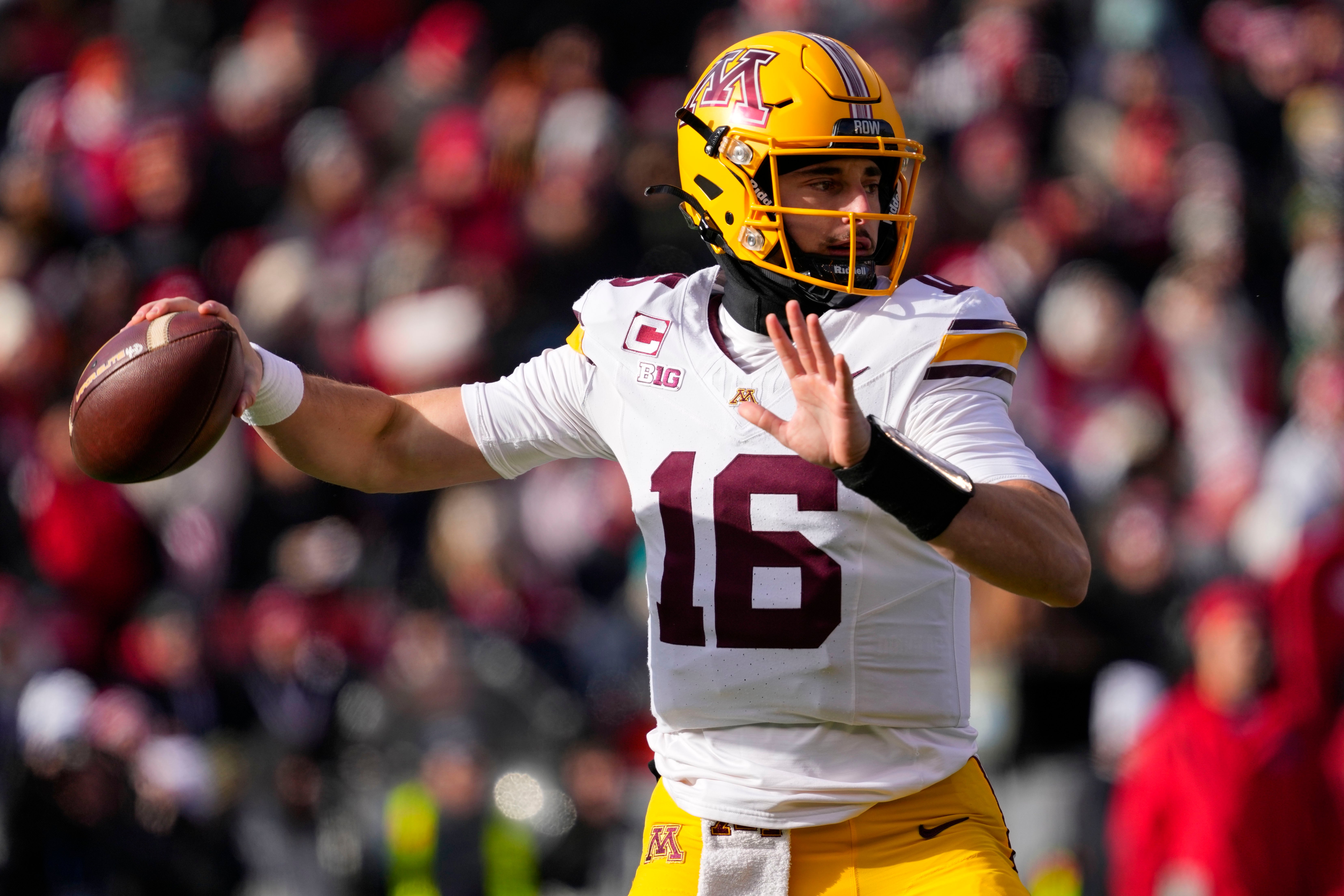 Nov 29, 2024; Madison, Wisconsin, USA; Minnesota Golden Gophers quarterback Max Brosmer (16) throws a pass during the first quarter against the Wisconsin Badgers at Camp Randall Stadium.