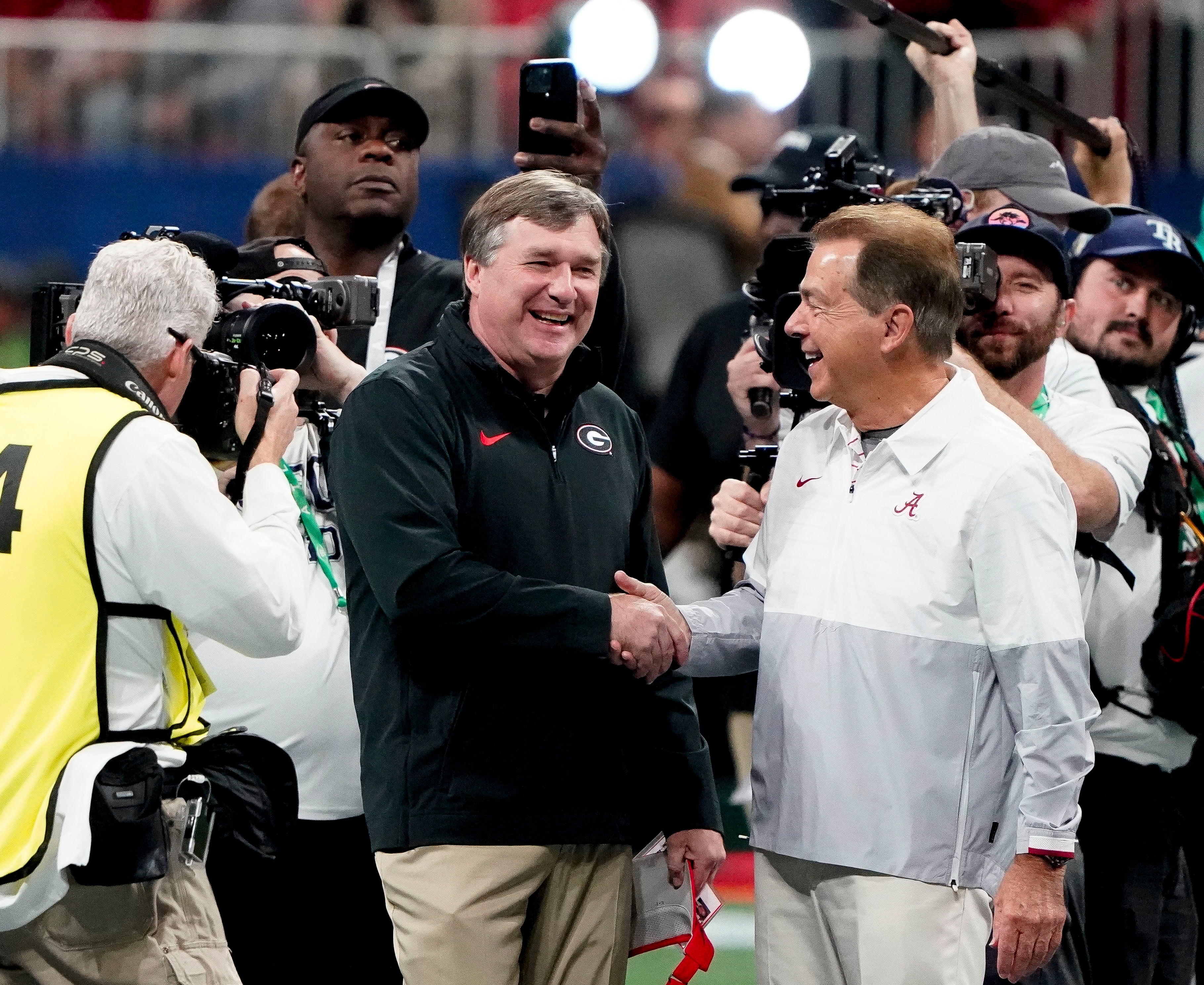 Georgia Bulldogs head coach Kirby Smart and Alabama Crimson Tide head coach Nick Saban meet before the SEC Championship Game at Mercedes-Benz Stadium.