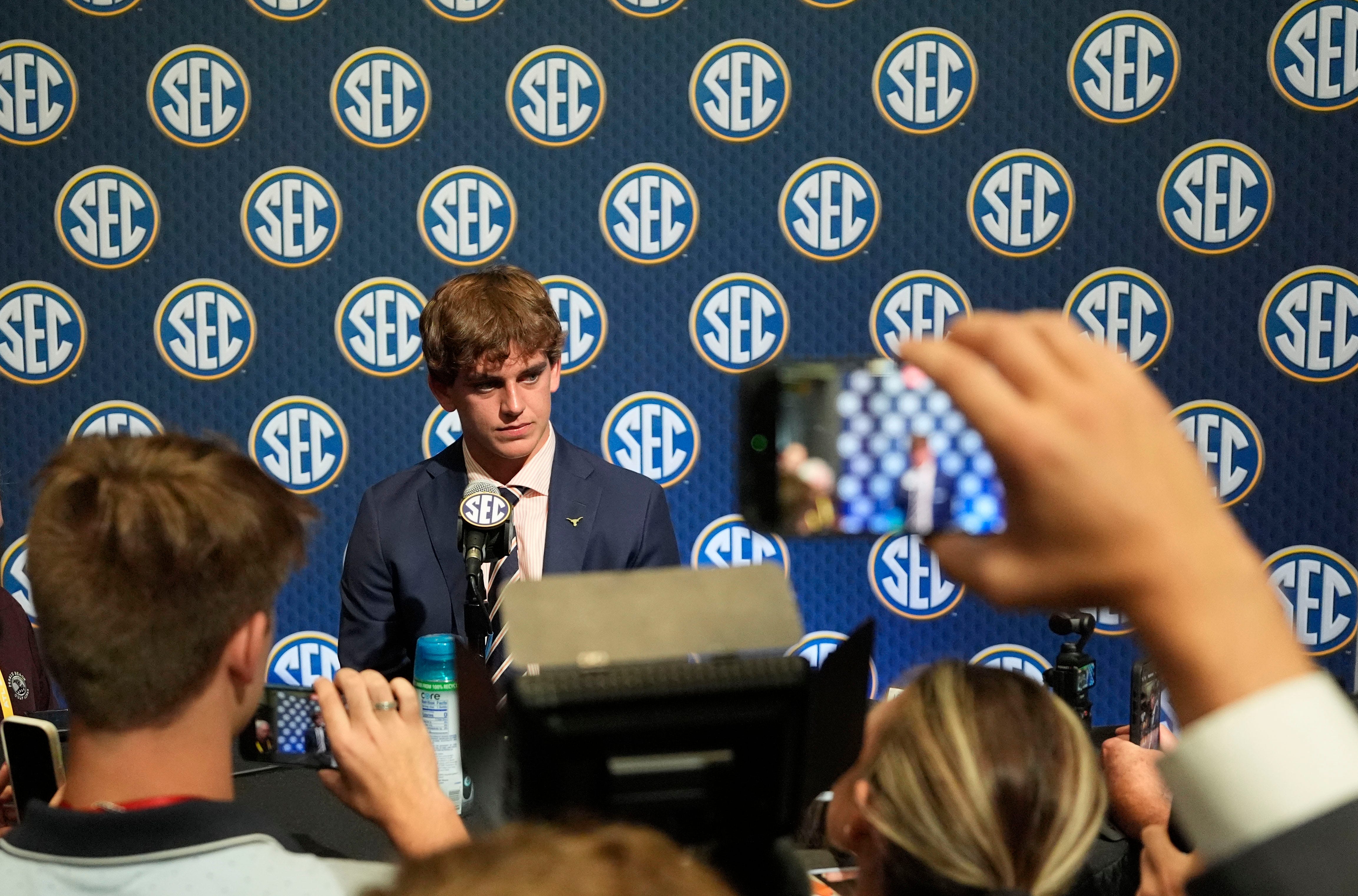 July 15, 2025; Atlanta, GA, USA; Texas quarterback Arch Manning listens to a question during SEC Media Days at the College Football Hall of Fame in Atlanta.