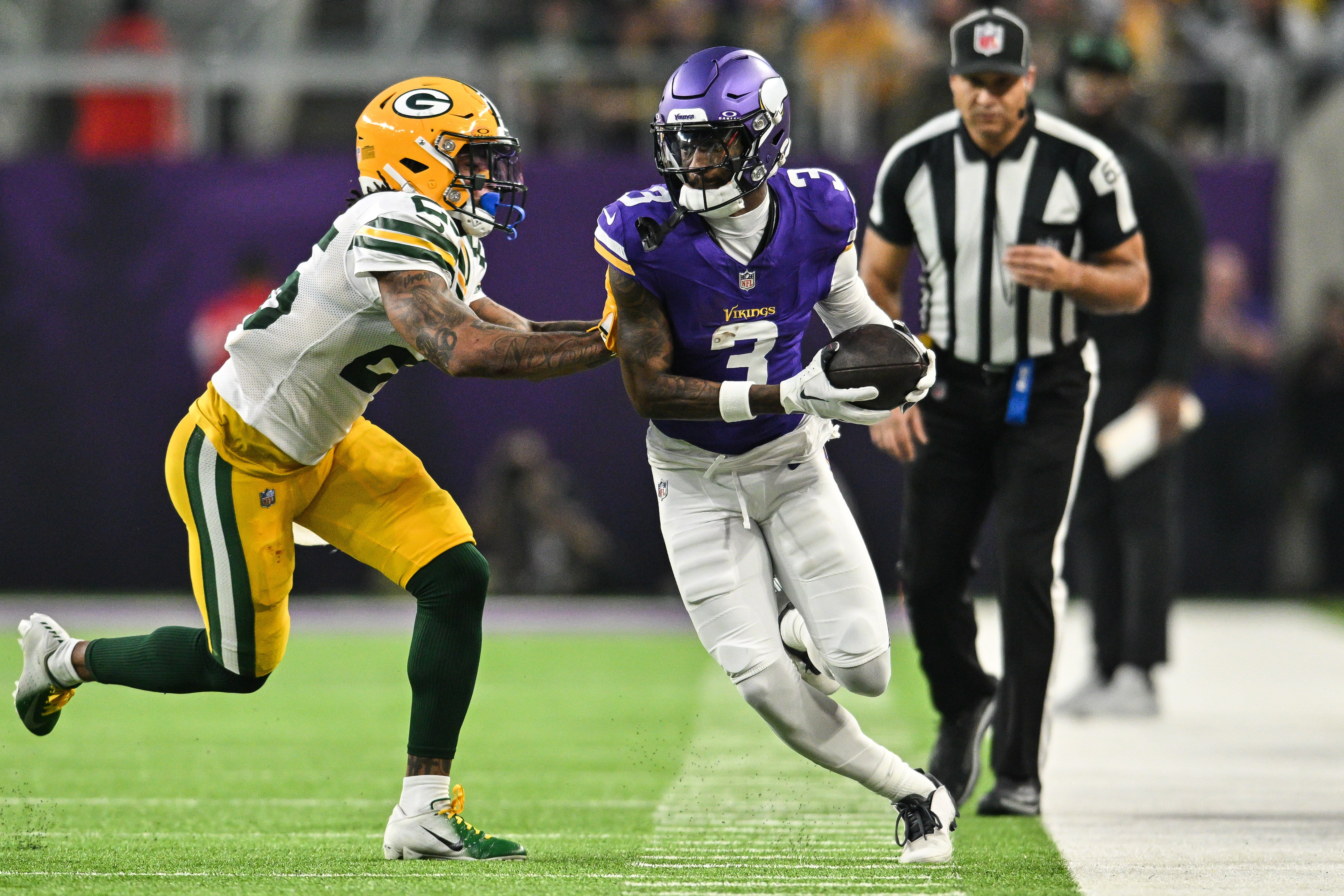 Dec 29, 2024; Minneapolis, Minnesota, USA; Minnesota Vikings wide receiver Jordan Addison (3) is knocked out of bounds by Green Bay Packers cornerback Keisean Nixon (25) during the second quarter at U.S. Bank Stadium.