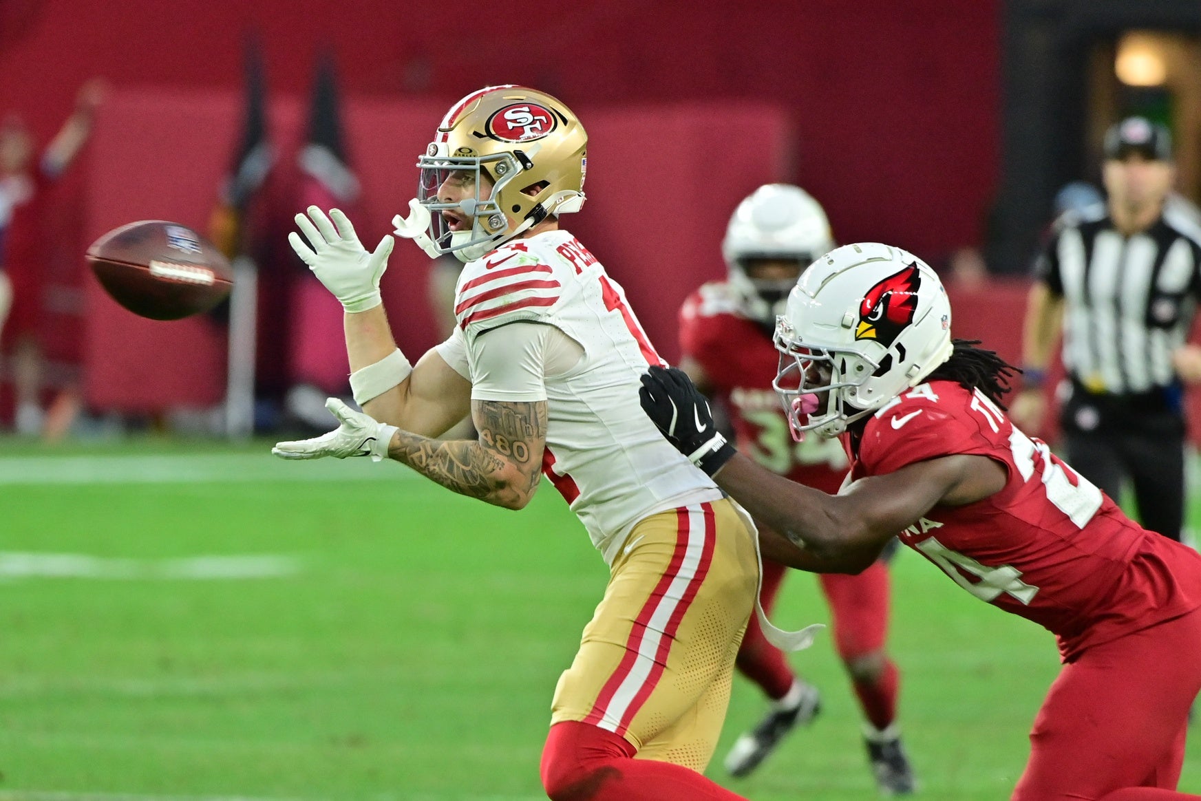 San Francisco 49ers wide receiver Ricky Pearsall (14) catches a pass as Arizona Cardinals cornerback Starling Thomas V (24) defends in the second half at State Farm Stadium.
