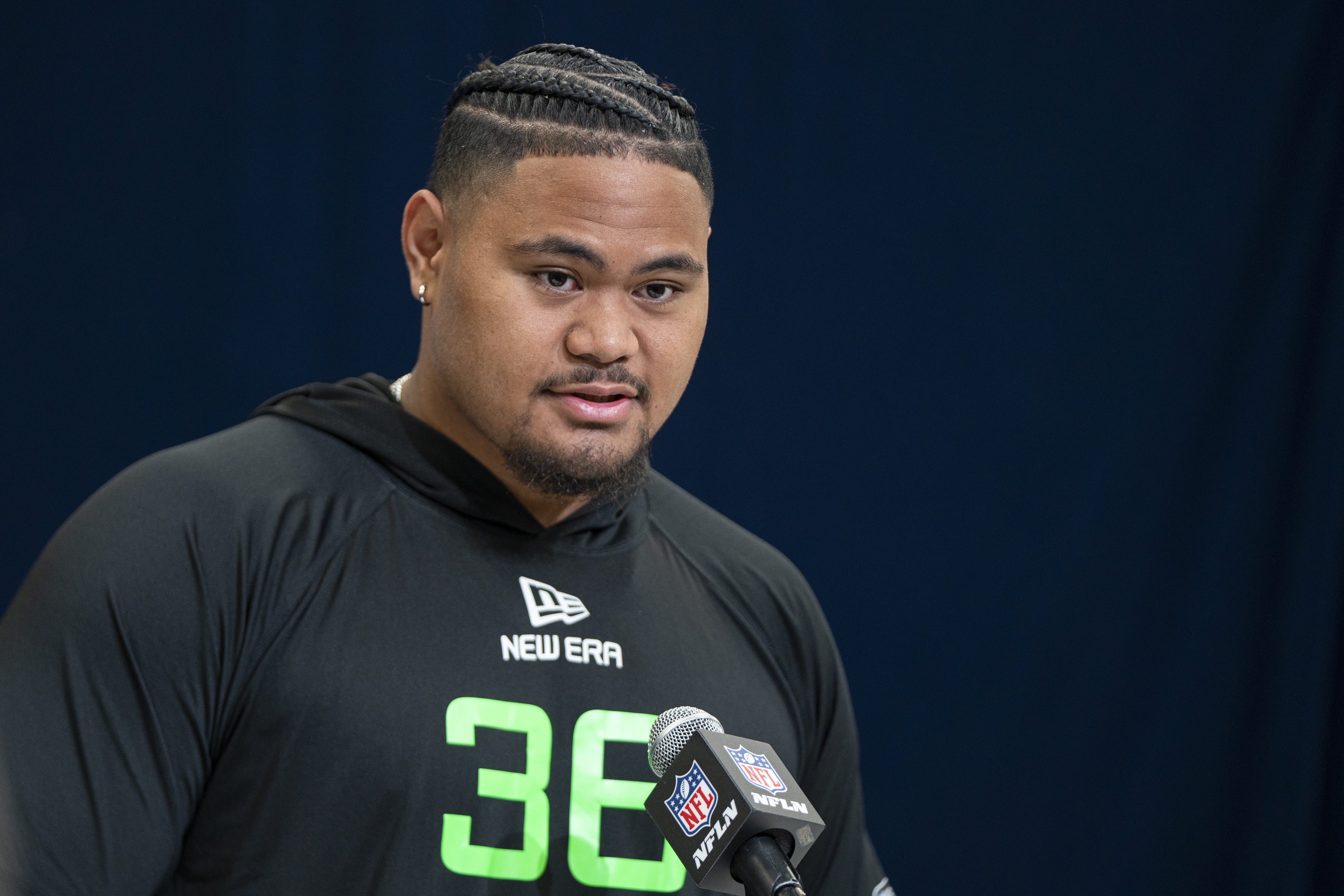 University of Arizona offensive lineman Jonah Savaiinaea (OL36) answers questions at a press conference during the 2025 NFL Combine at Indiana Convention Center