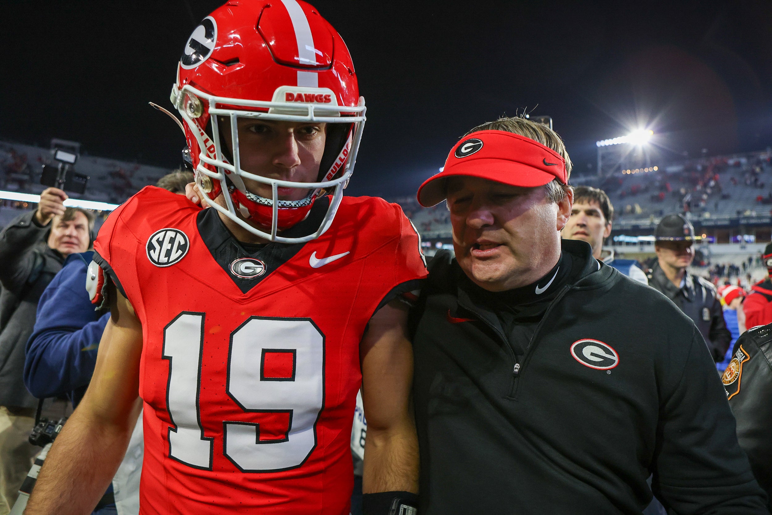 Georgia Bulldogs tight end Brock Bowers (19) and head coach Kirby Smart walk off the field after defeating the Georgia Tech Yellow Jackets at Bobby Dodd Stadium at Hyundai Field.
