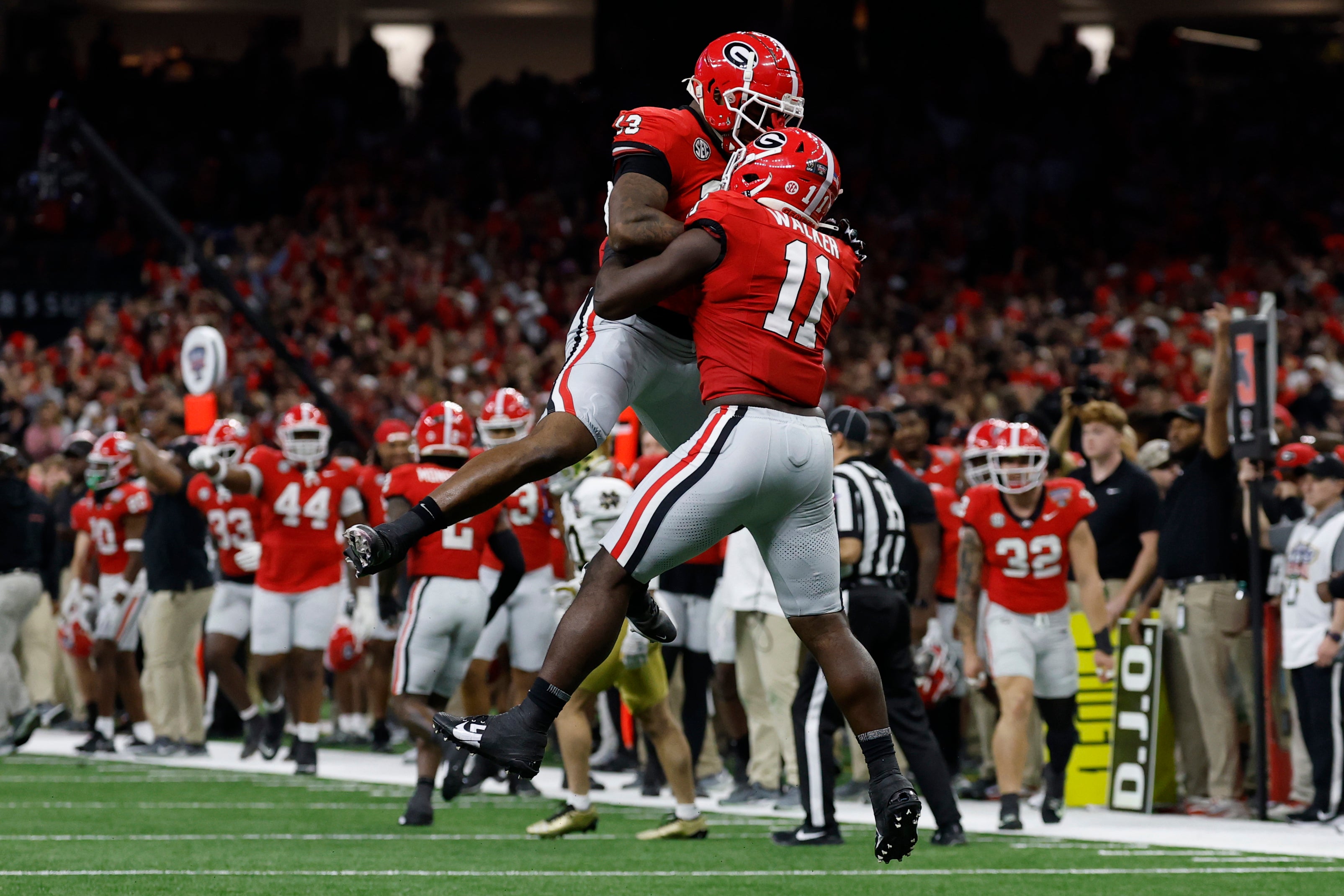 Jan 2, 2025; New Orleans, LA, USA; Georgia Bulldogs linebacker Jalon Walker (11) celebrates with Bulldogs defensive lineman Mykel Williams (13) after making a defensive stop against the Notre Dame Fighting Irish during the first quarter at Caesars Superdome.