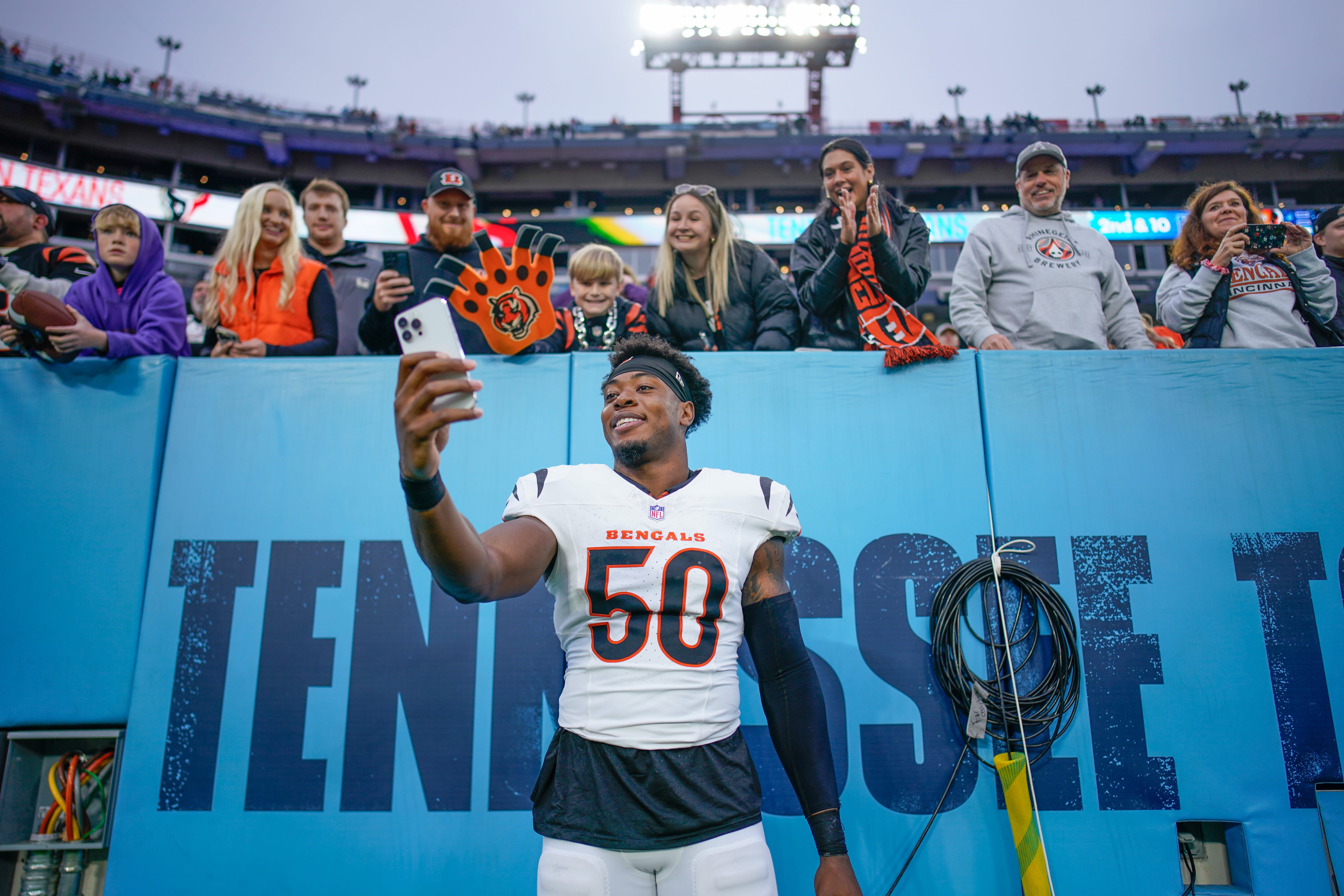 Cincinnati Bengals linebacker Shaka Heyward (50) takes a photo with fans after the game against the Tennessee Titans at Nissan Stadium in Nashville, Tenn., Sunday, Dec. 15, 2024.