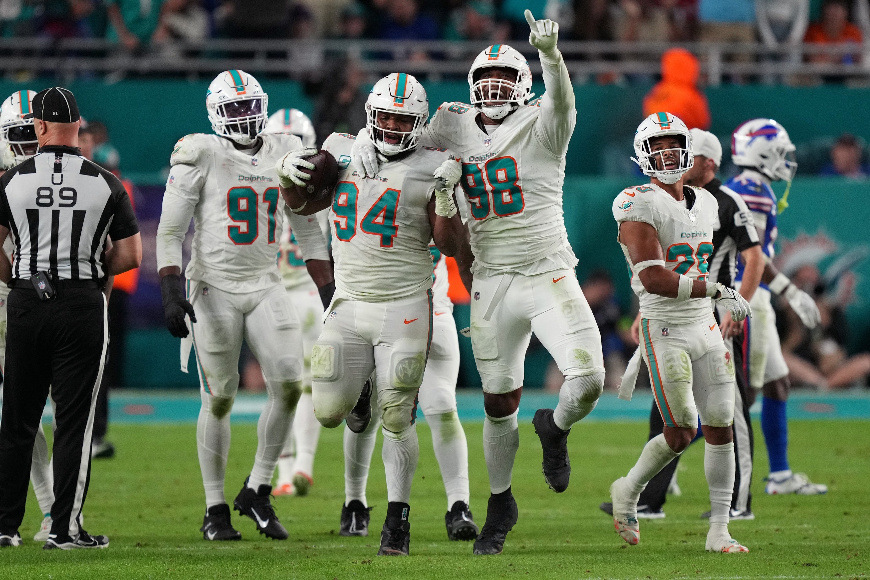 Miami Dolphins defensive tackle Christian Wilkins (94) celebrates a fumble recovery against the Buffalo Bills with teammate defensive tackle Raekwon Davis (98) during the second half at Hard Rock Stadium.