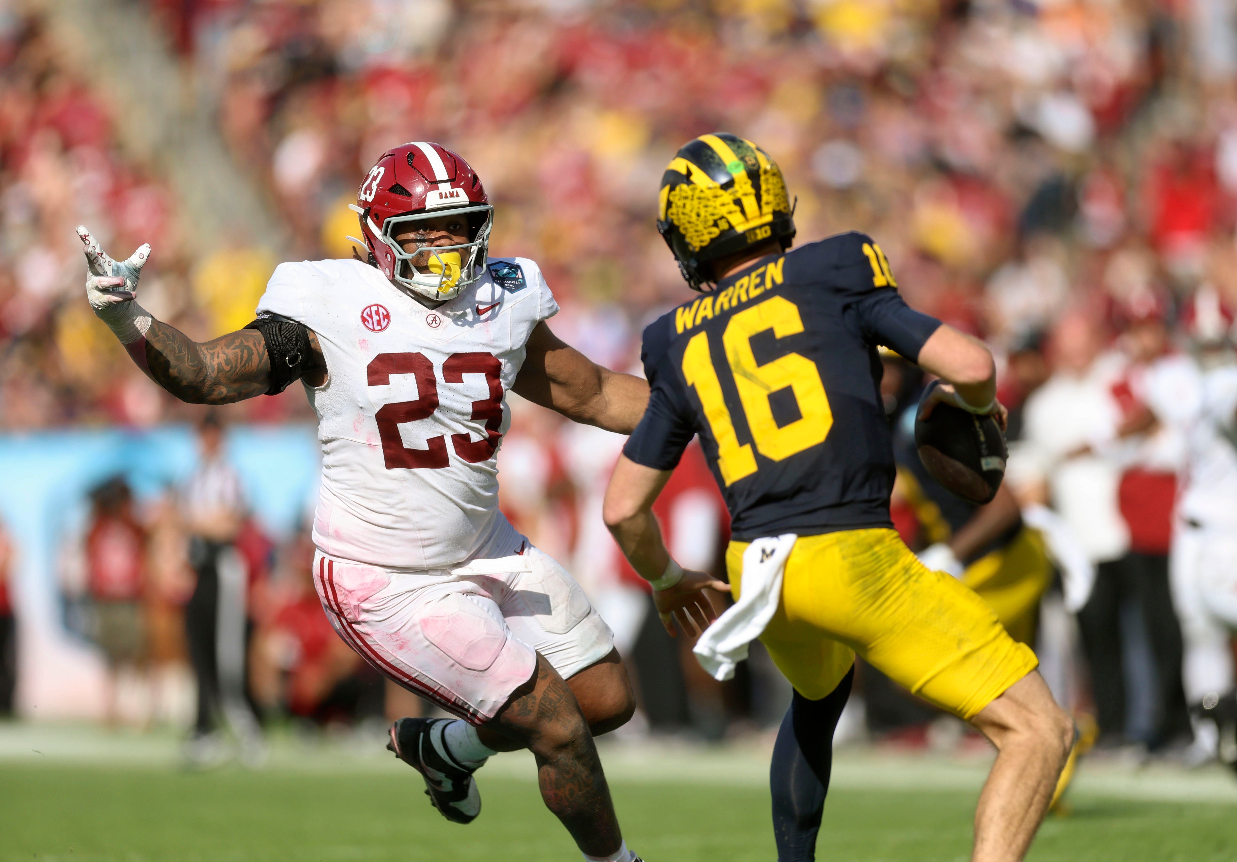 Alabama defensive lineman James Smith attempts to sack Michigan quarterback Davis Warren in the ReliaQuest Bowl in Orlando, Florida. Photo credit: Alabama Athletics