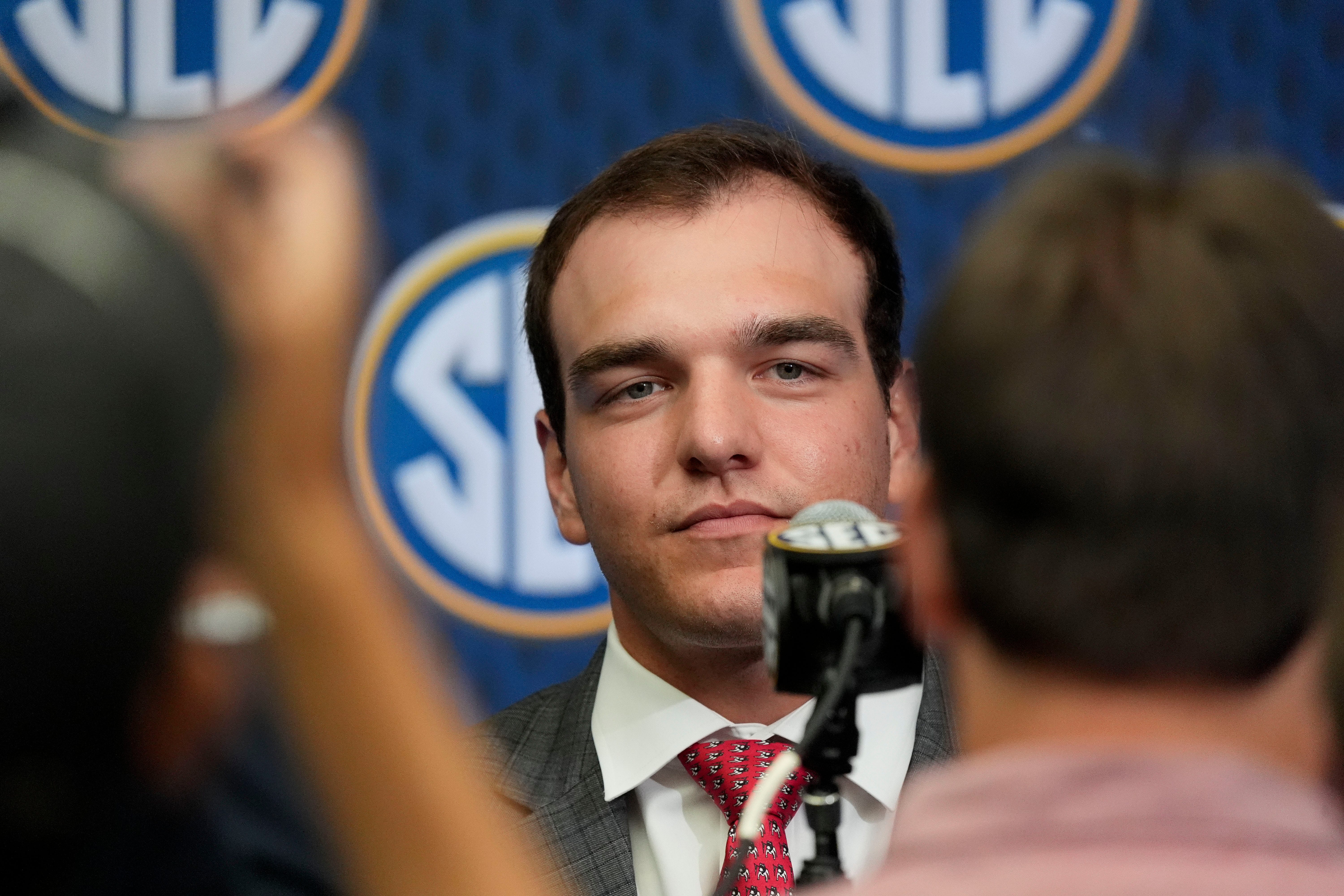 Georgia quarterback Gunner Stockton listens to a question in the Main Media Room during SEC Media Days at the College Football Hall of Fame.
