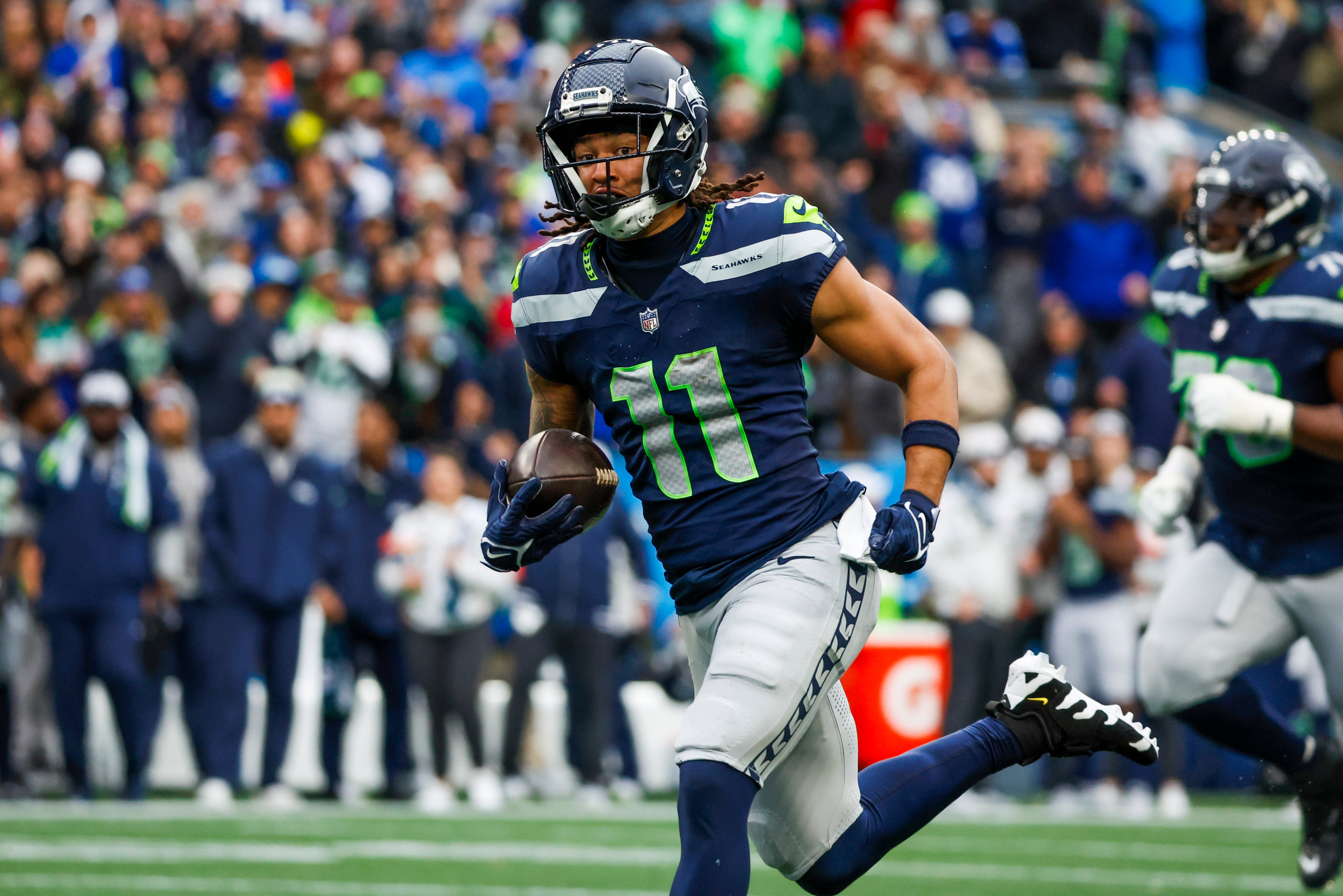 Nov 24, 2024; Seattle, Washington, USA; Seattle Seahawks wide receiver Jaxon Smith-Njigba (11) runs for yards after the catch against the Arizona Cardinals during the second quarter at Lumen Field.